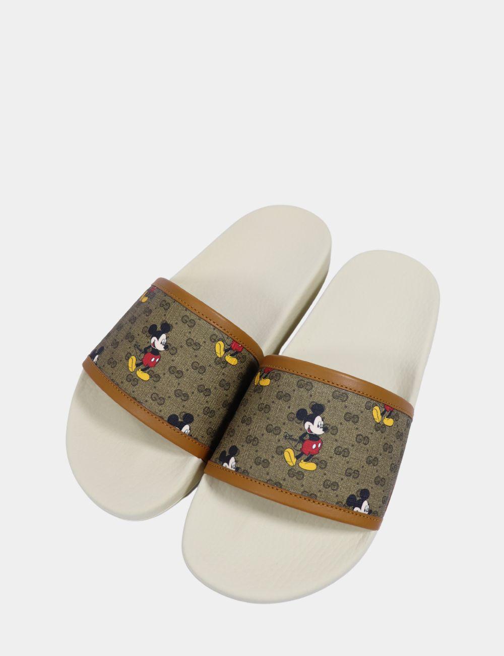 Bring playful luxury to your casual style with these Gucci x Disney GG Supreme Mickey Mouse Slides. Part of the limited-edition collaboration between Gucci and Disney, these slides feature the iconic GG Supreme canvas adorned with a cheerful Mickey