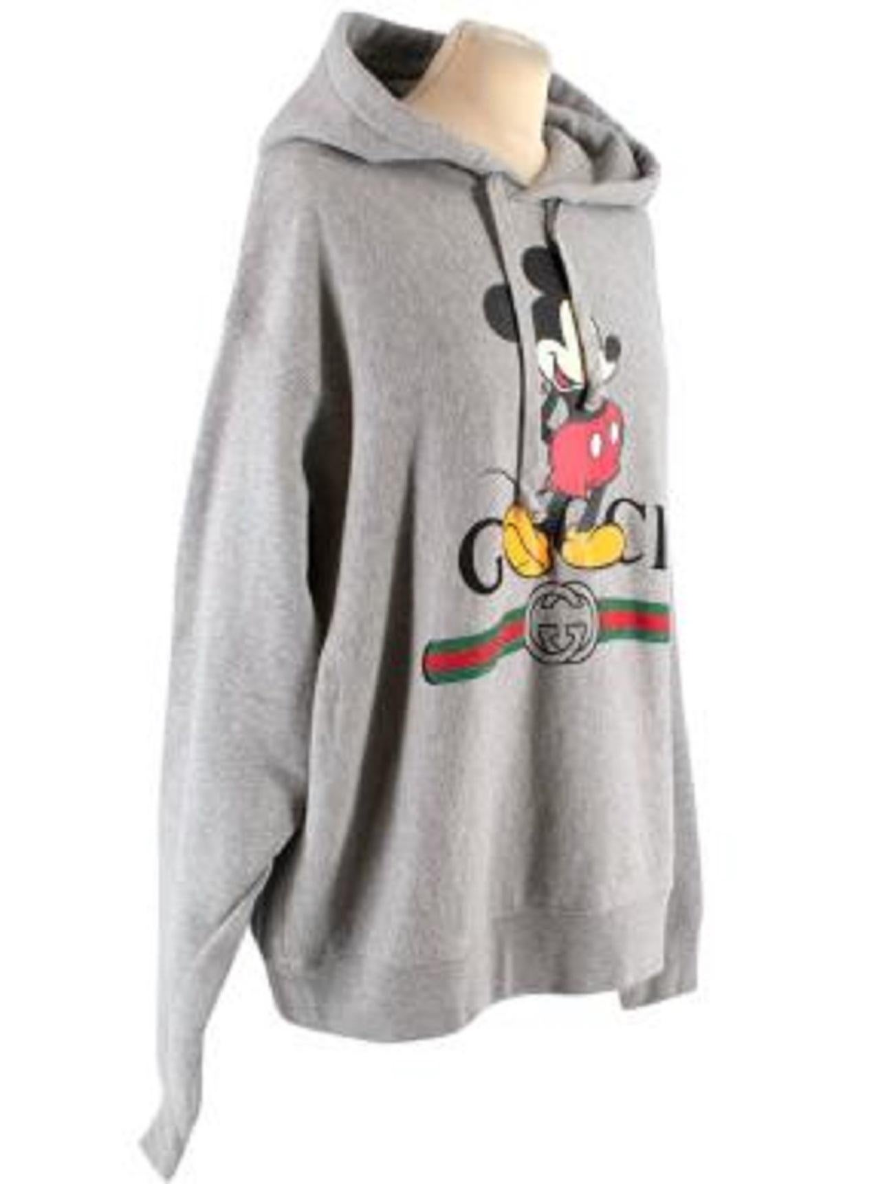 Gucci x Disney Grey Mickey Mouse Hoodie

-Ribbed cuffs & hem 
-Mouse is printed over the infamous Gucci logo
-Drawstring hood
-Dropped shoulders

Material: 

100% Cotton 

Made in Italy 

9.5/10 excellent conditions, please refer to images for