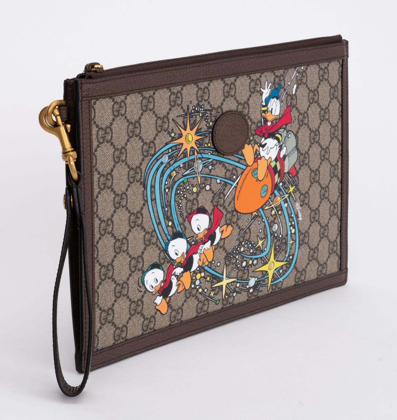 Gucci x Disney limited edition Donald Duck clutch. Detachable leather handle, comes with original booklets and dust cover.