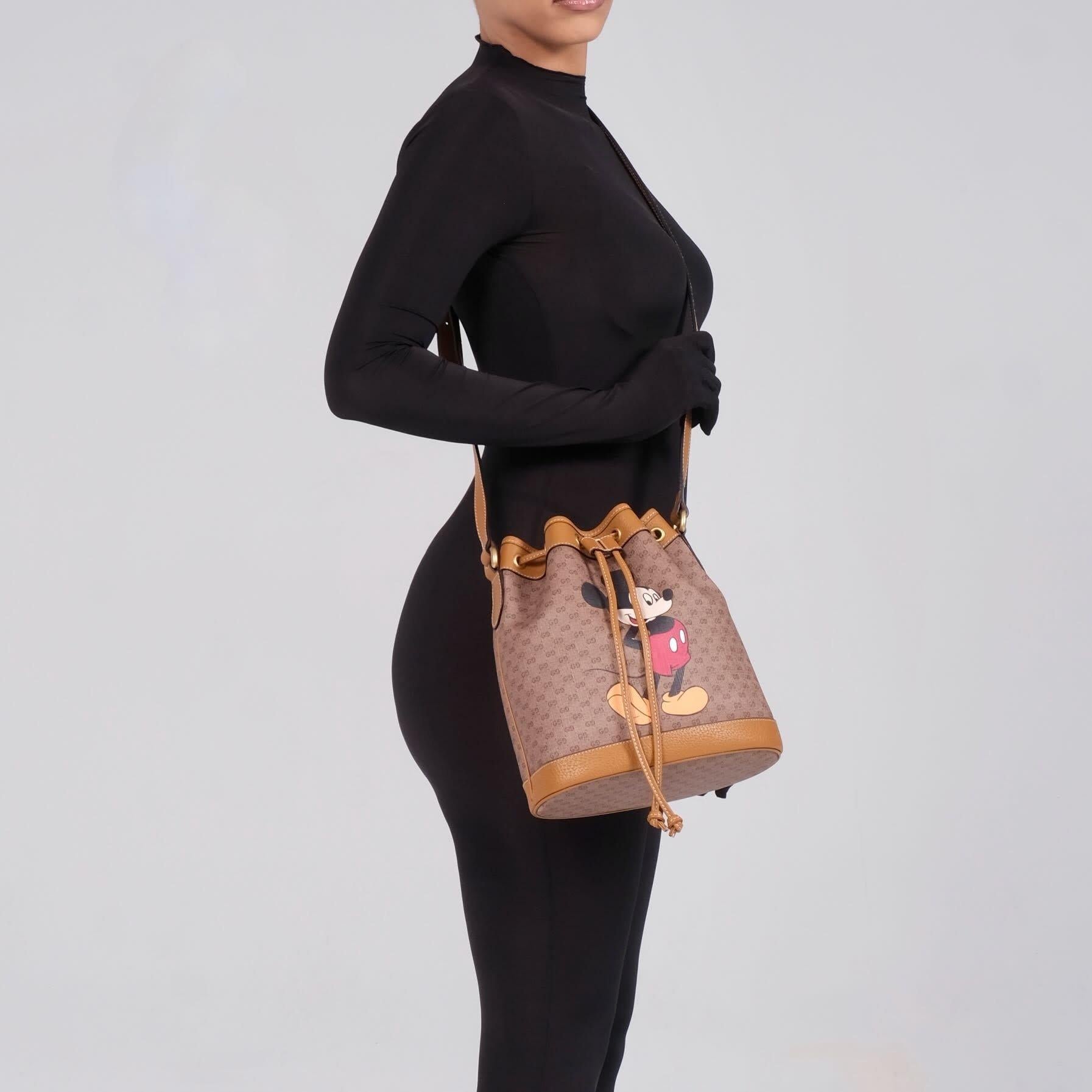 Color: ebony with Micky & monogram print
Material: Coated canvas with leather details
Model No.602691
Comes with: Dust bag
Condition: Pristine. Like new condition.
Made in Italy

Measurements~
Height 10.75”
Width 11.75”
Depth 4.75”
Drop 20-23”