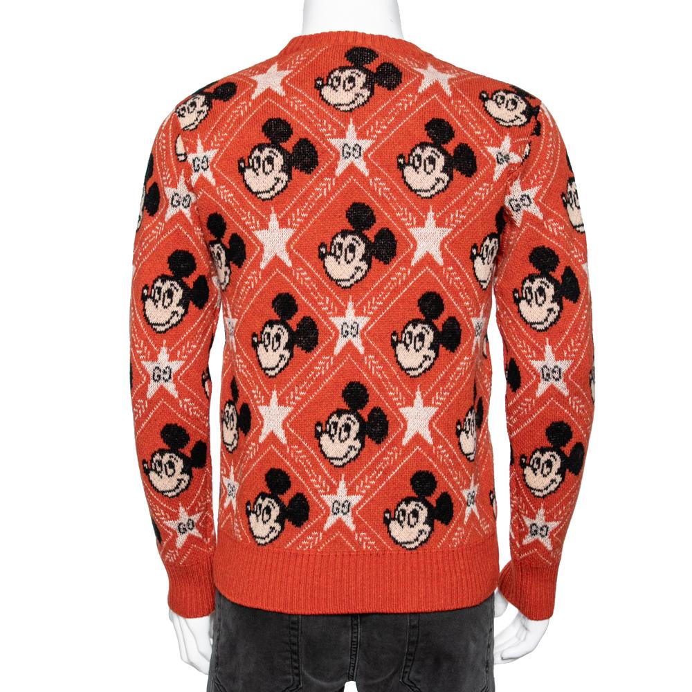 From the Gucci x Disney collaboration comes this bright orange sweater that is switched from quality wool. It features a Mickey Mouse print all over and is finished with long sleeves and a crew neck. It will look cool with jeans and