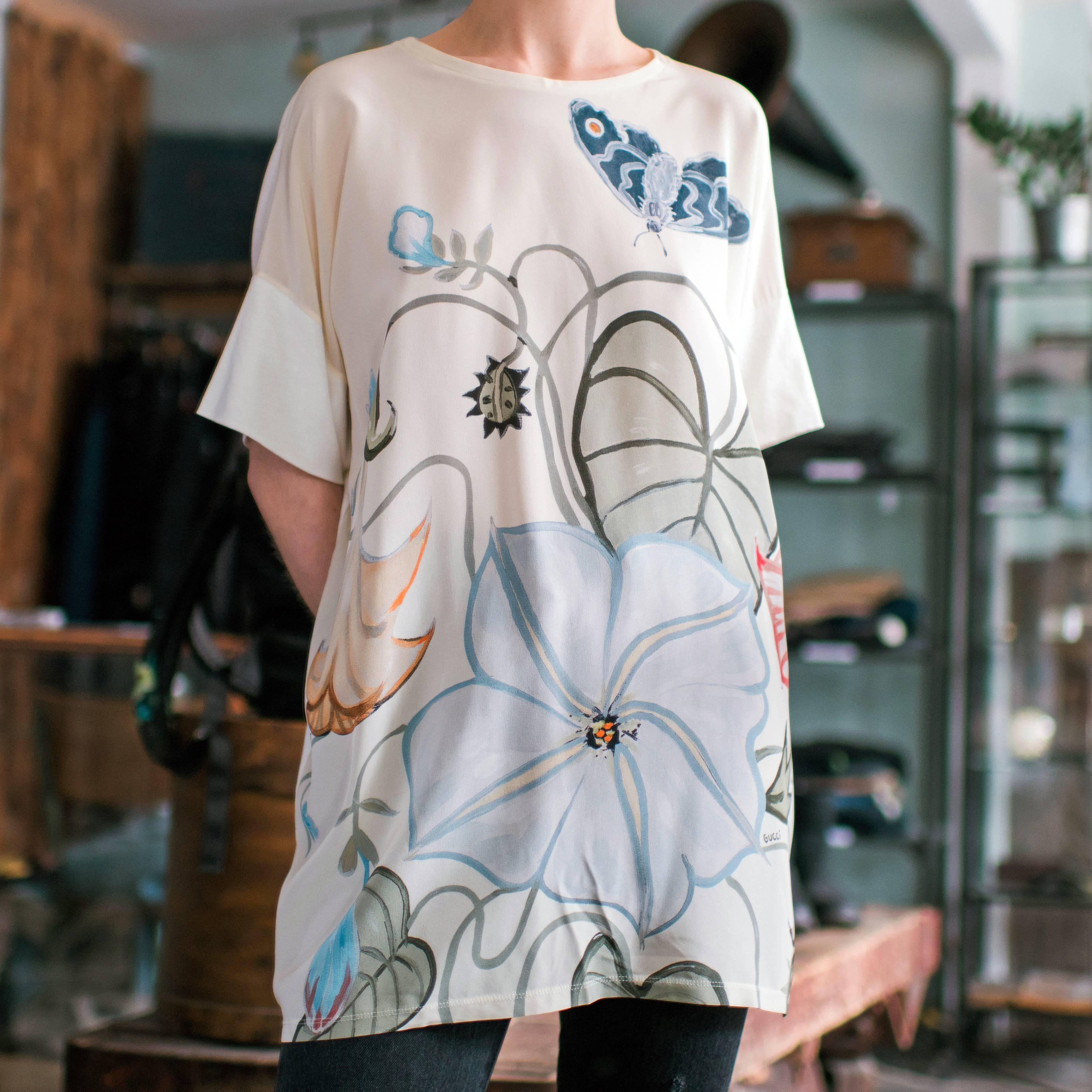 Gucci collaborated with artist Kris Knight on their resort 2015 collection to design this floral and butterfly pattern shirt. Size tag has been removed but fits as an oversized and loose USA 6 / 8. Garment bust and hip measures 50”. Recommended for