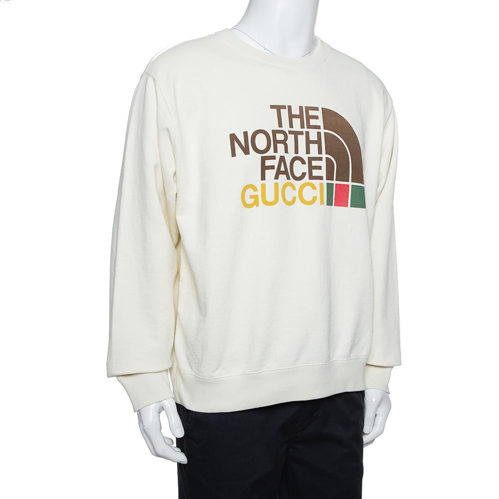 In a recent collaboration with The North Face, Gucci celebrates the quintessence of exploration and adventure. The sweatshirt is made from 100% cotton in a creamish shade and features The North Face's famous half-domed stripe logo melded with