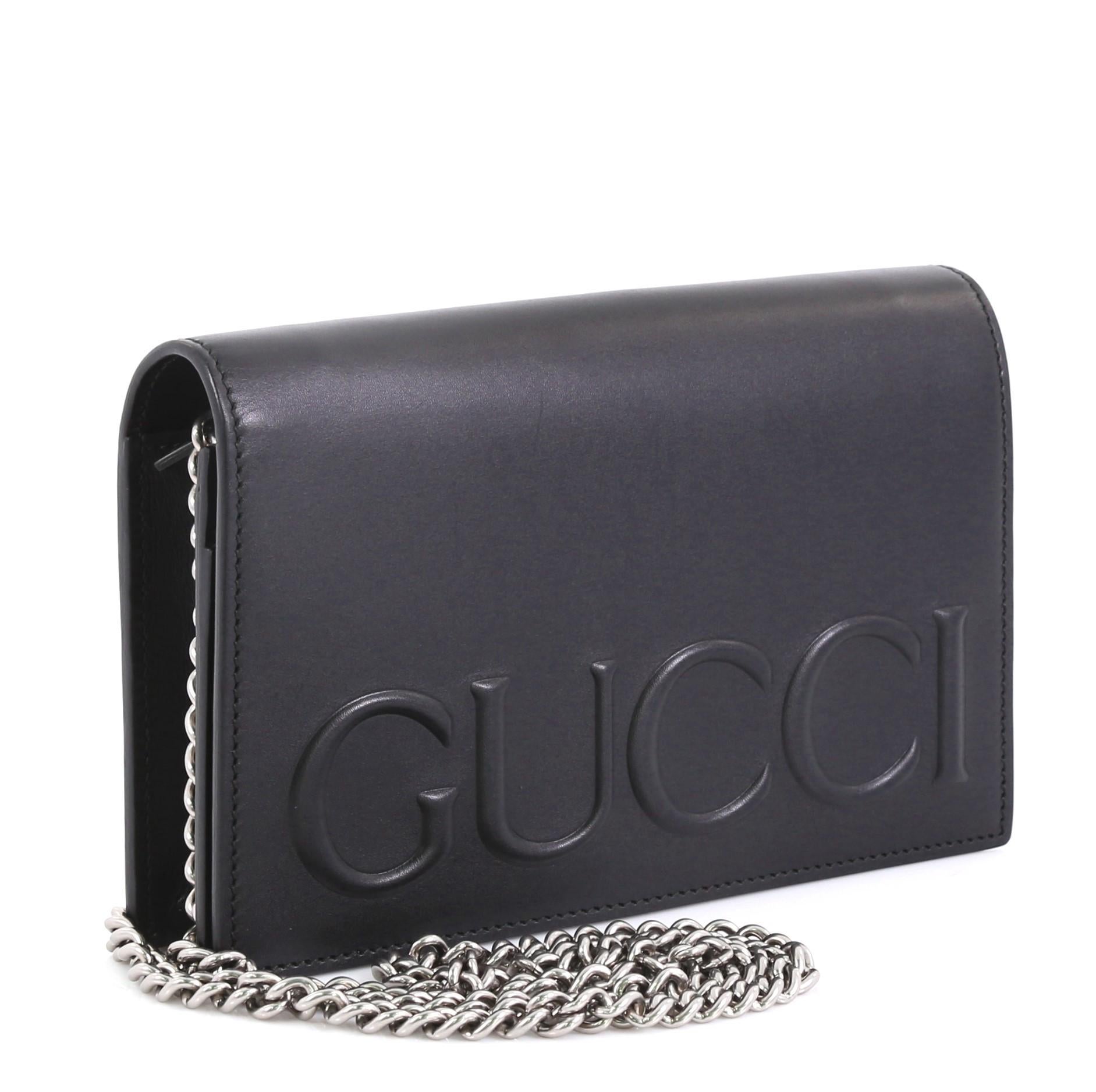 This Gucci XL Chain Shoulder Bag Leather Mini, crafted in smooth black leather, features an embossed Gucci logo, detachable chain-link strap and aged silver-tone hardware. Its button snap closure opens to a black leather interior with slip and zip