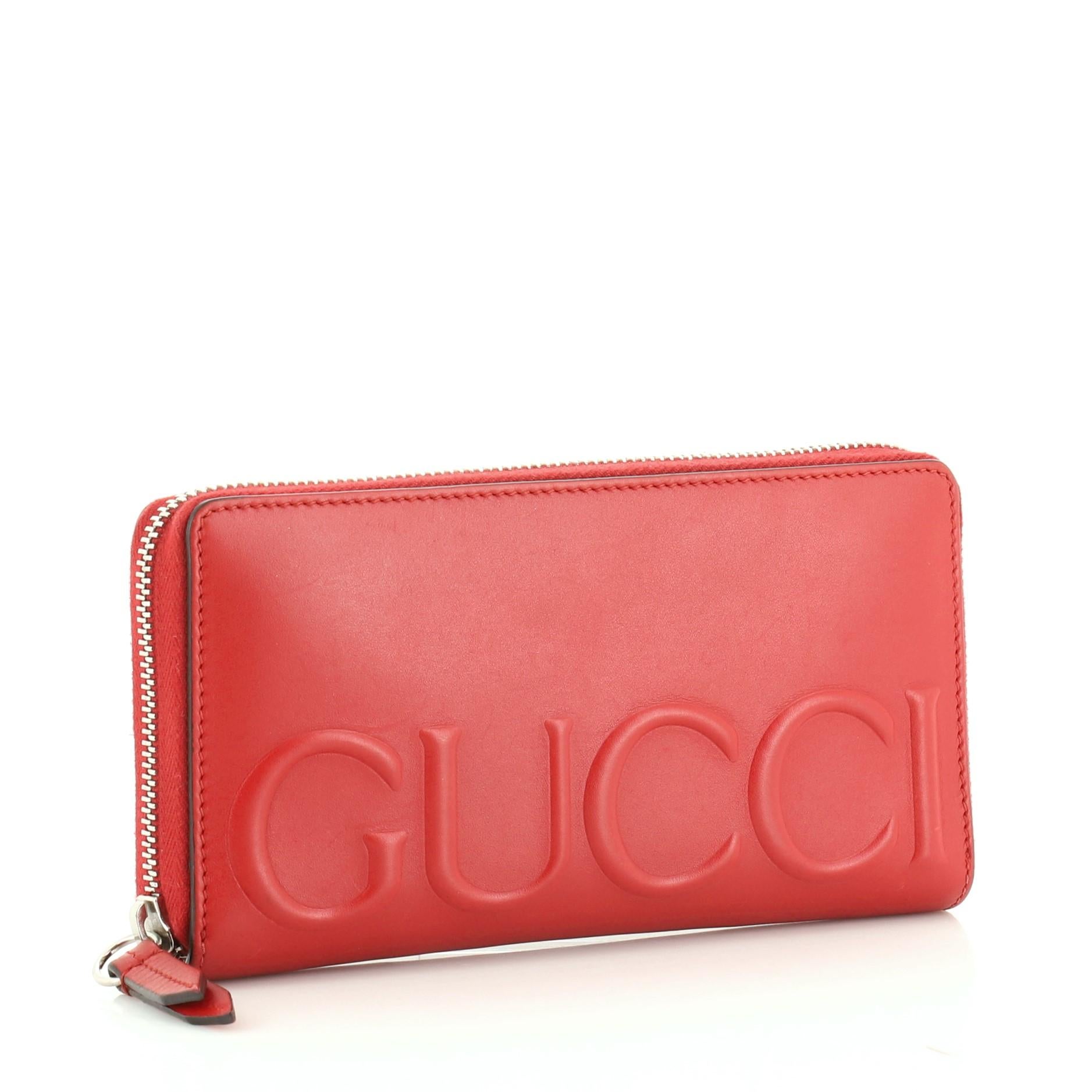 This Gucci XL Zip Around Wallet Leather, crafted in red leather, features an embossed Gucci logo on front and silver-tone hardware. Its zip closure opens to a red leather interior with multiple card slots and zip pocket. 

Estimated Retail Price: