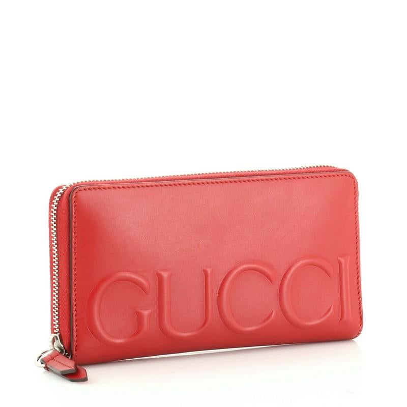 This Gucci XL Zip Around Wallet Leather, crafted in red leather, features an embossed Gucci logo on front and silver-tone hardware. Its zip closure opens to a red leather interior with multiple card slots and zip pocket. 

Condition: Very good.