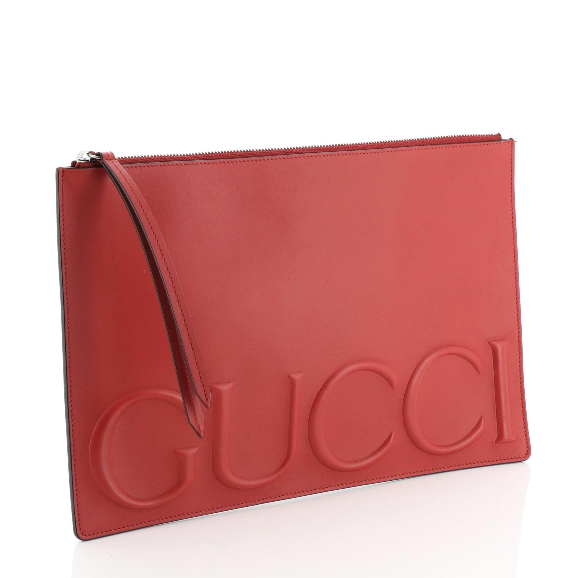 This Gucci XL Zip Clutch Leather is an evening piece perfect for a night out on the town. Crafted from red leather, it features an embossed Gucci logo on front and silver-tone hardware. Its zip closure opens to a black fabric interior. 

Estimated