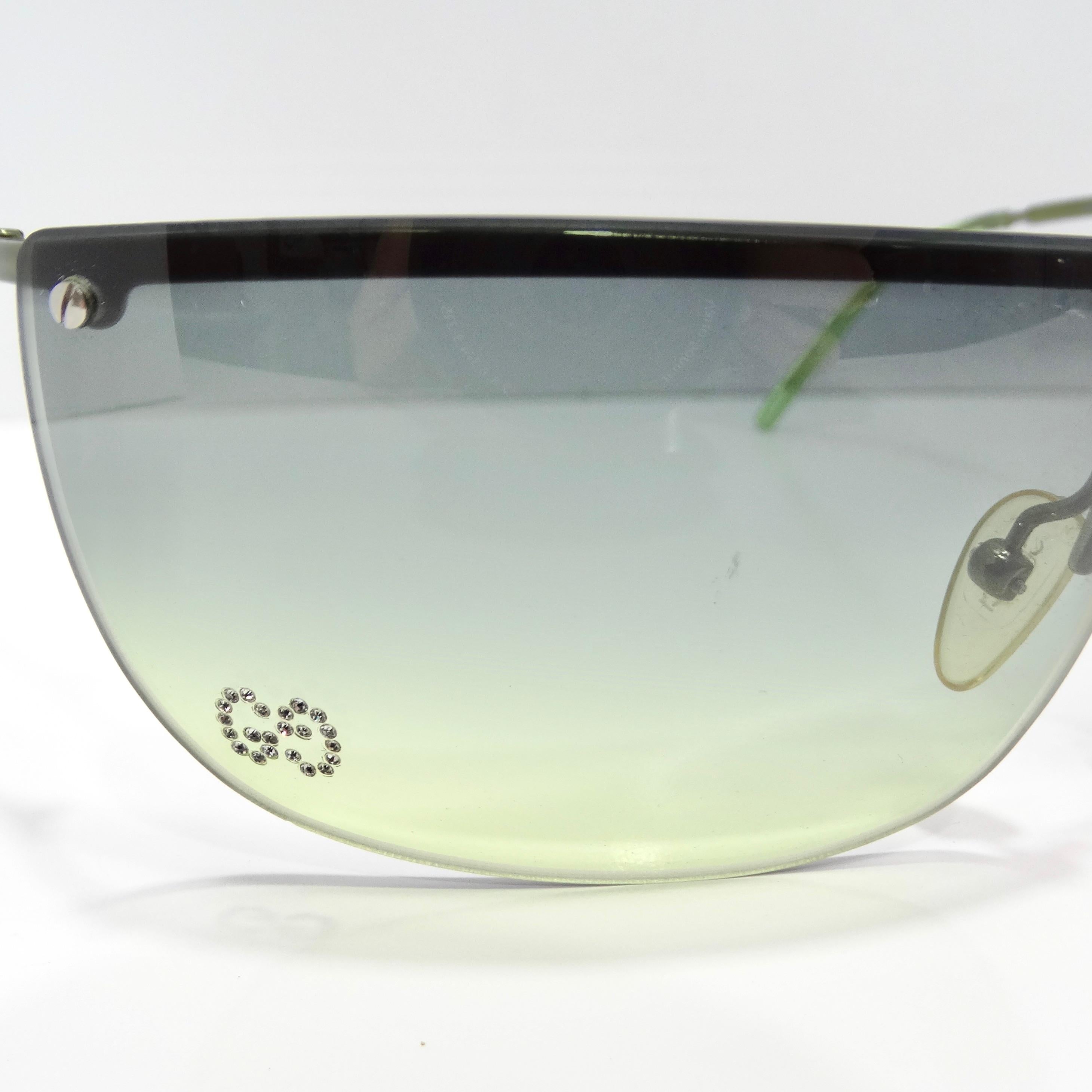 Make a bold statement with the Gucci Y2K Green Gradient Sunglasses. These rimless sunglasses capture the essence of early 2000s style with their vibrant blue and green gradient lenses. Adding a touch of glamour, a rhinestone GG Gucci logo