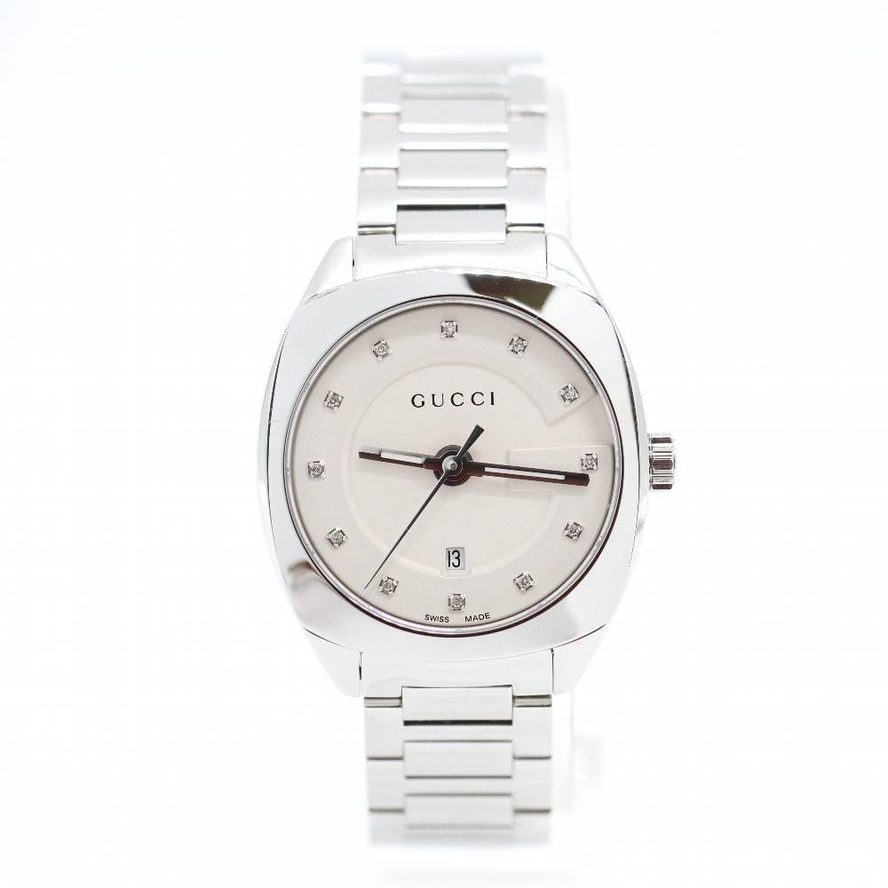 GUCCI BRILLANTES Watch YA142504 Brand New Watch, steel case 29mm excluding crown. Case thickness 8mm. Sapphire crystal. Very fine white slightly silvered dial adorned with 12 tiny diamonds. Stainless steel bangle, 14mm wide. Push button clasp.