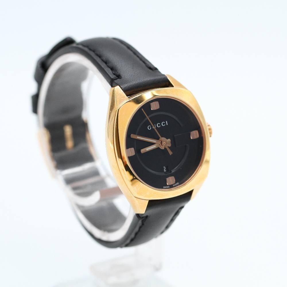 GUCCI Watch YA142509 Brand New, 29mm rose gold plated stainless steel case excluding crown. Case thickness 8mm. Sapphire crystal. Black dial with rose gold hands. Black leather strap. Clip clasp. Strap width 18mm. Quartz movement. Water resistant