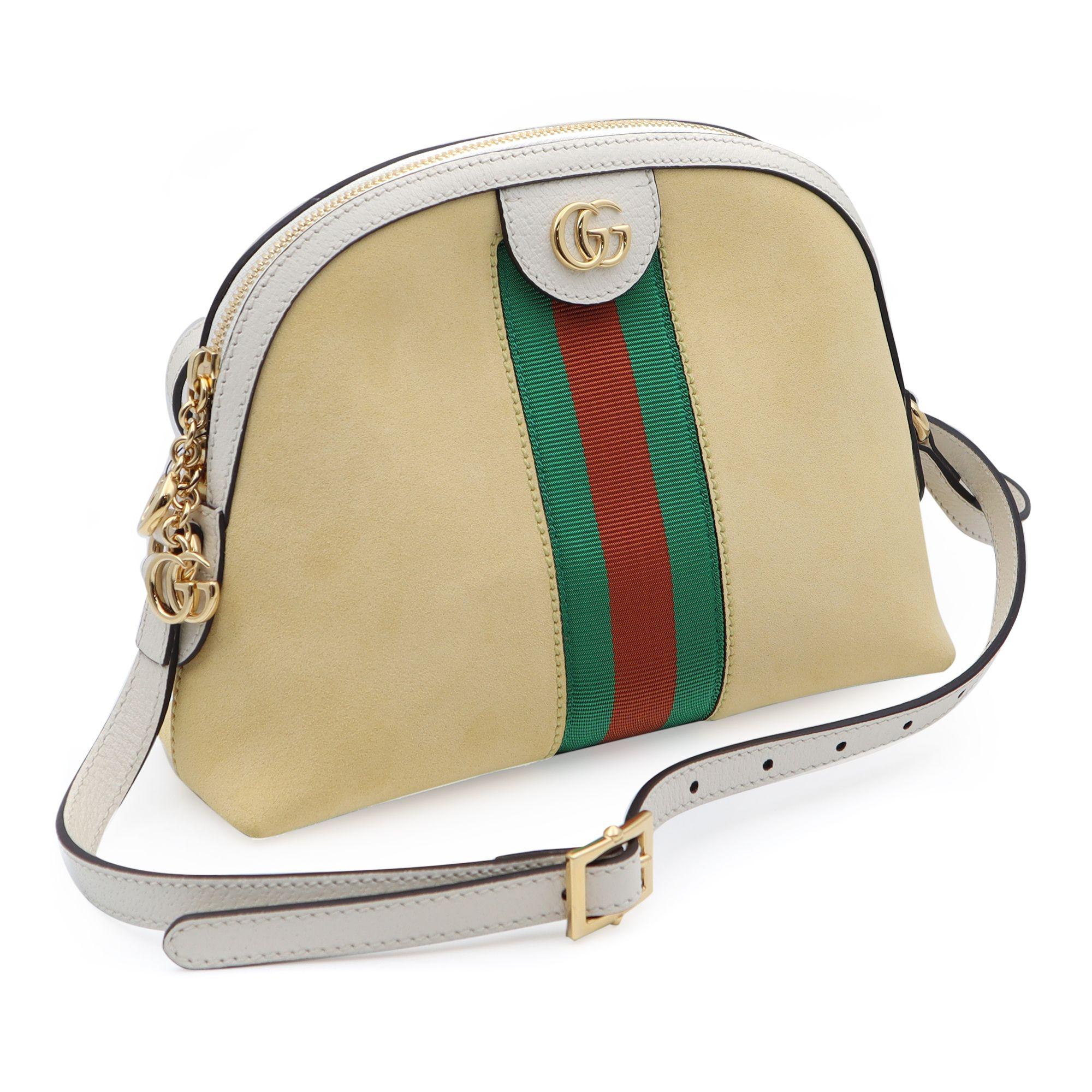 This Gucci Ophidia crossbody bag is crafted of yellow suede with white leather trim. The bag features an adjustable white leather shoulder strap and gold hardware. The top zipper opens to a beige fabric interior with patch pockets. This bag has room