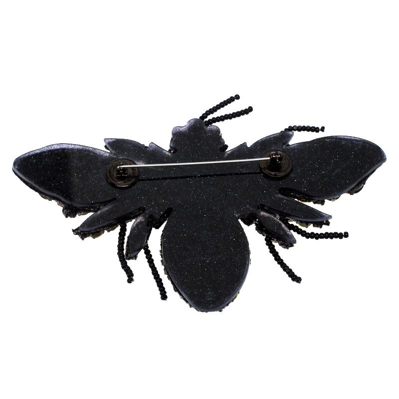 In the shape of a bumblebee comes this Gucci brooch made from black resin. It is detailed the crystals and beads on the front and signature engravings at the back. With a pin fastening at the back, it is for sure a smart accessory to have and