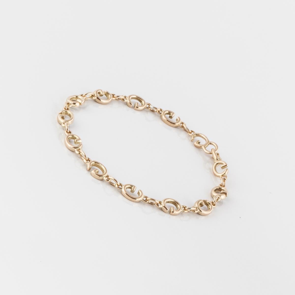 18K yellow gold bracelet by Gucci.  The links are the letter 