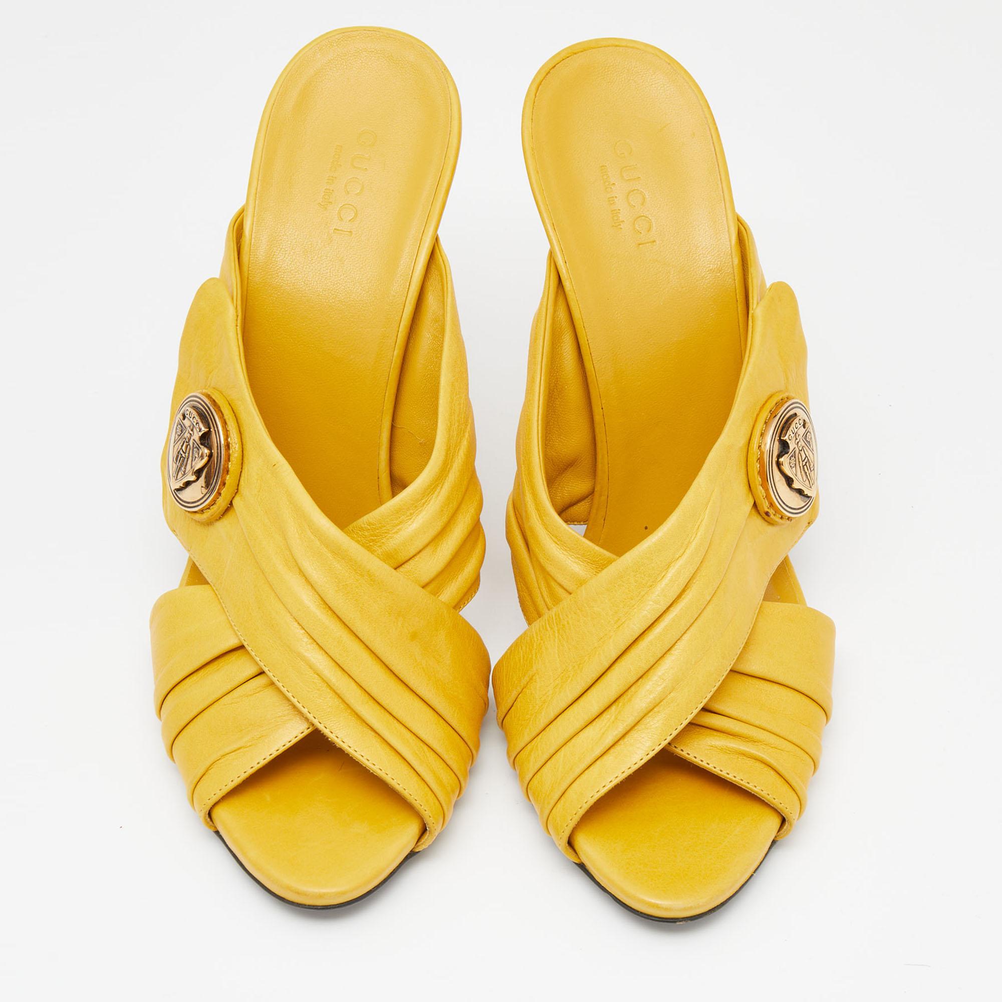Wear these elegant and minimal Gucci slides that will assist you on many occasions. The vibrant yellow sandals are made from leather and are accented with gold-tone brand emblems and 11 cm heels for the right amount of elevation.

Includes: Original