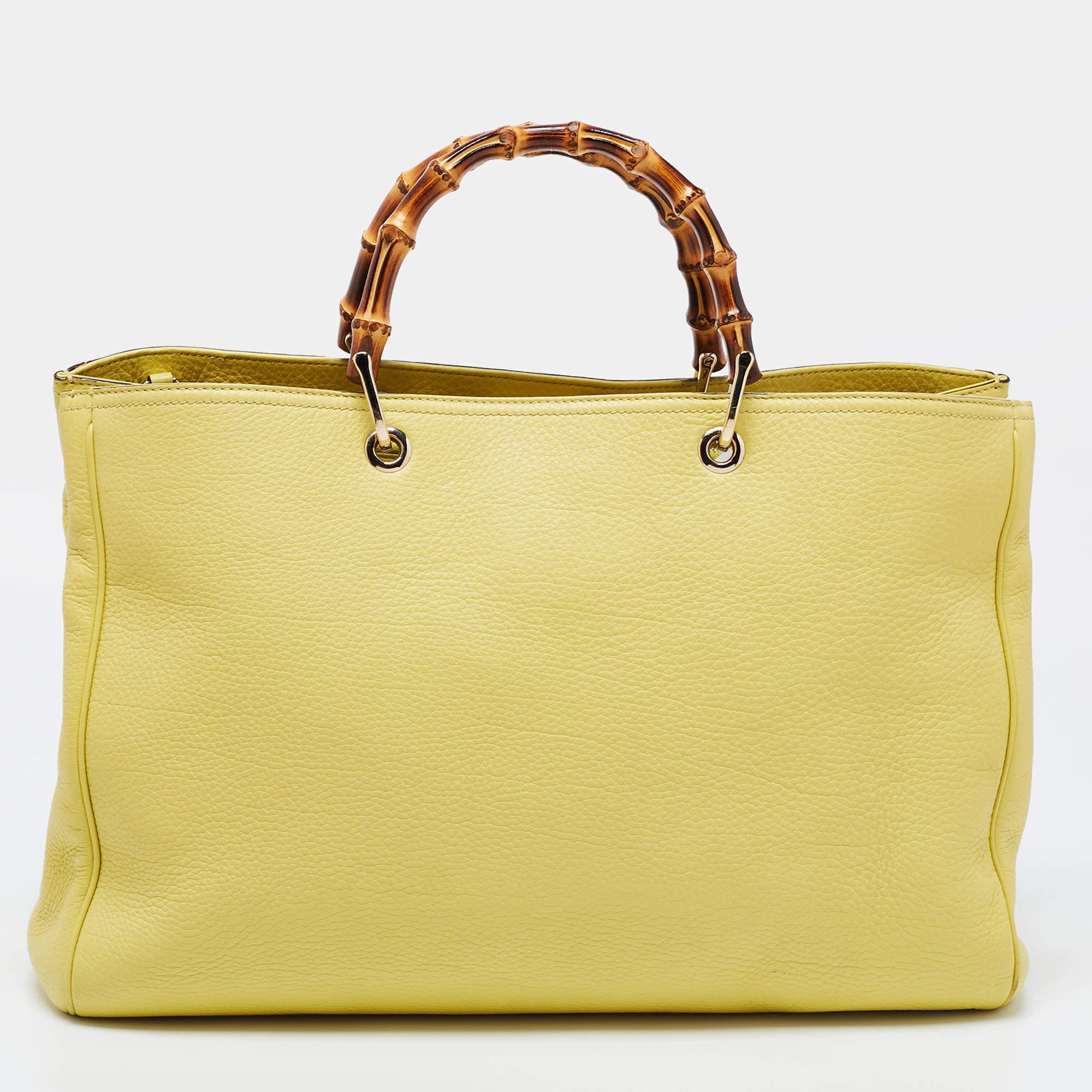 
This Bamboo Shopper tote from Gucci is perfect for all seasons. Crafted from leather, this bag features bamboo handles, gold-tone hardware, and a shoulder strap. Its top opens to a lined interior that offers you ample space for everyday