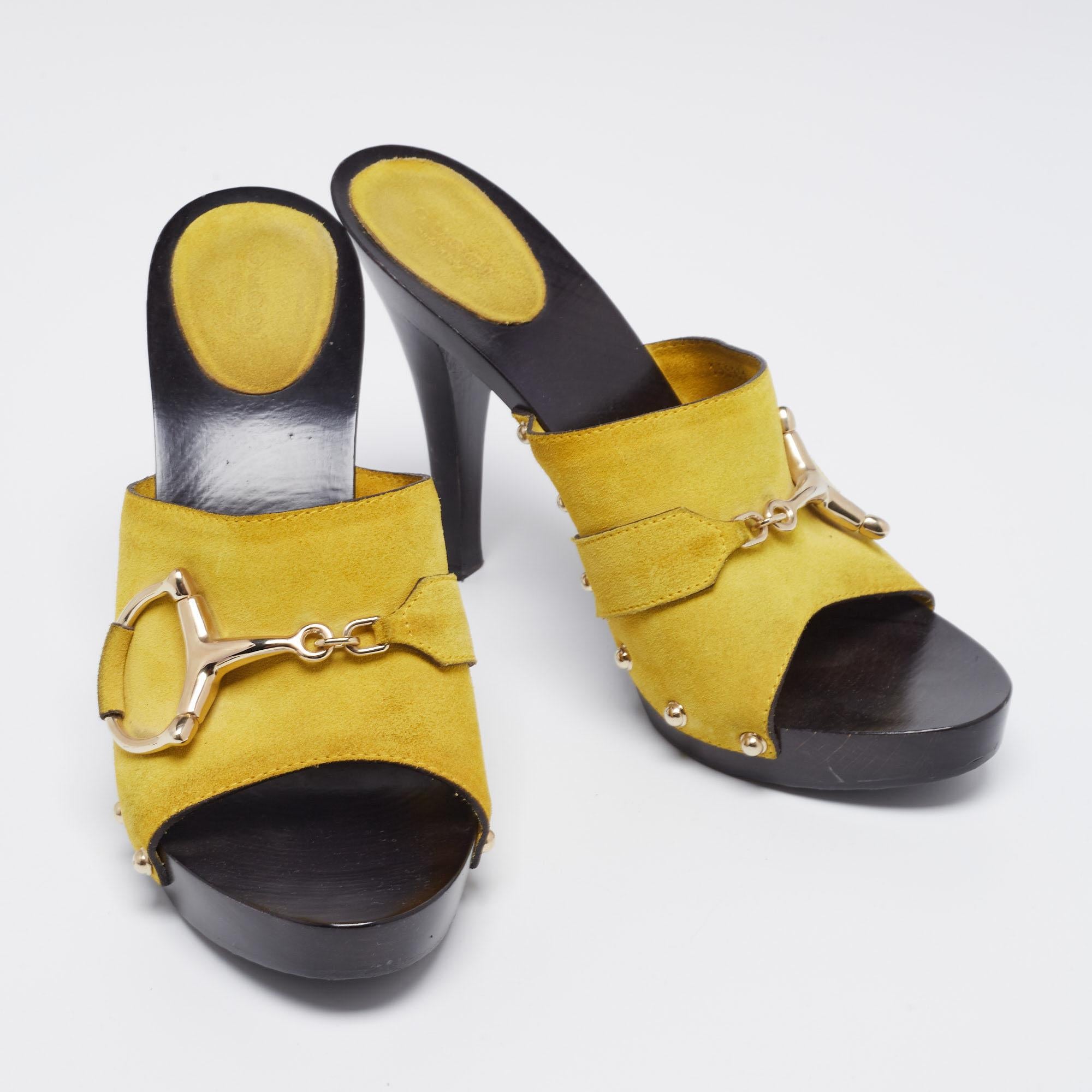 Gucci presents its own take on 1970s style with clogs in yellow-colored suede with signature Horsebit motif. They boast clog-style silver studs, Horsebits, and a wooden platform and heel for a chunky look. Perfect with a maxi dress at a summer