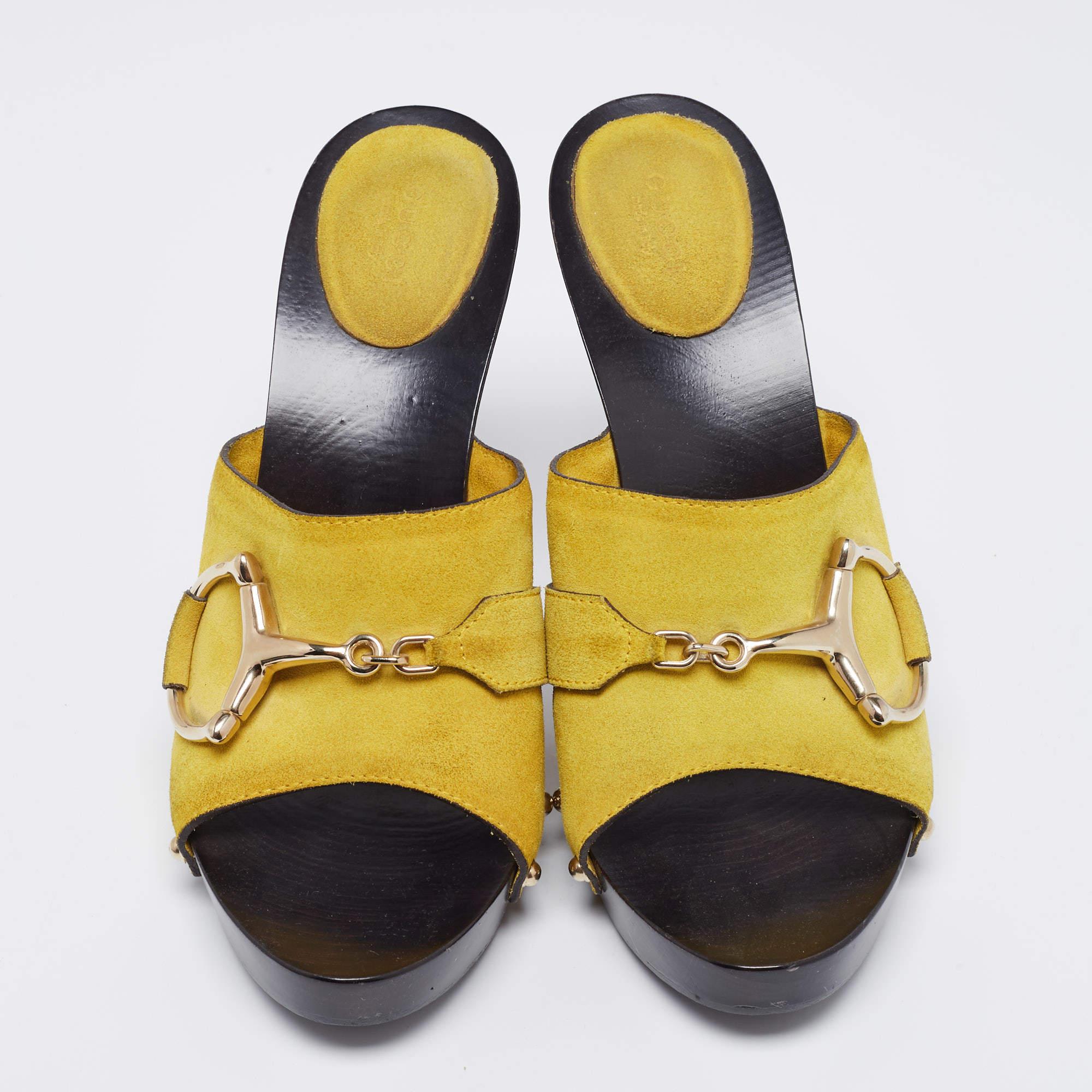 Gucci presents its own take on 1970s style with clogs in yellow-colored suede with signature Horsebit motif. They boast clog-style silver studs, Horsebits, and a wooden platform and heel for a chunky look. Perfect with a maxi dress at a summer