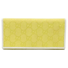 Gucci - Portefeuille continental en toile et cuir GG jaune/blanc
