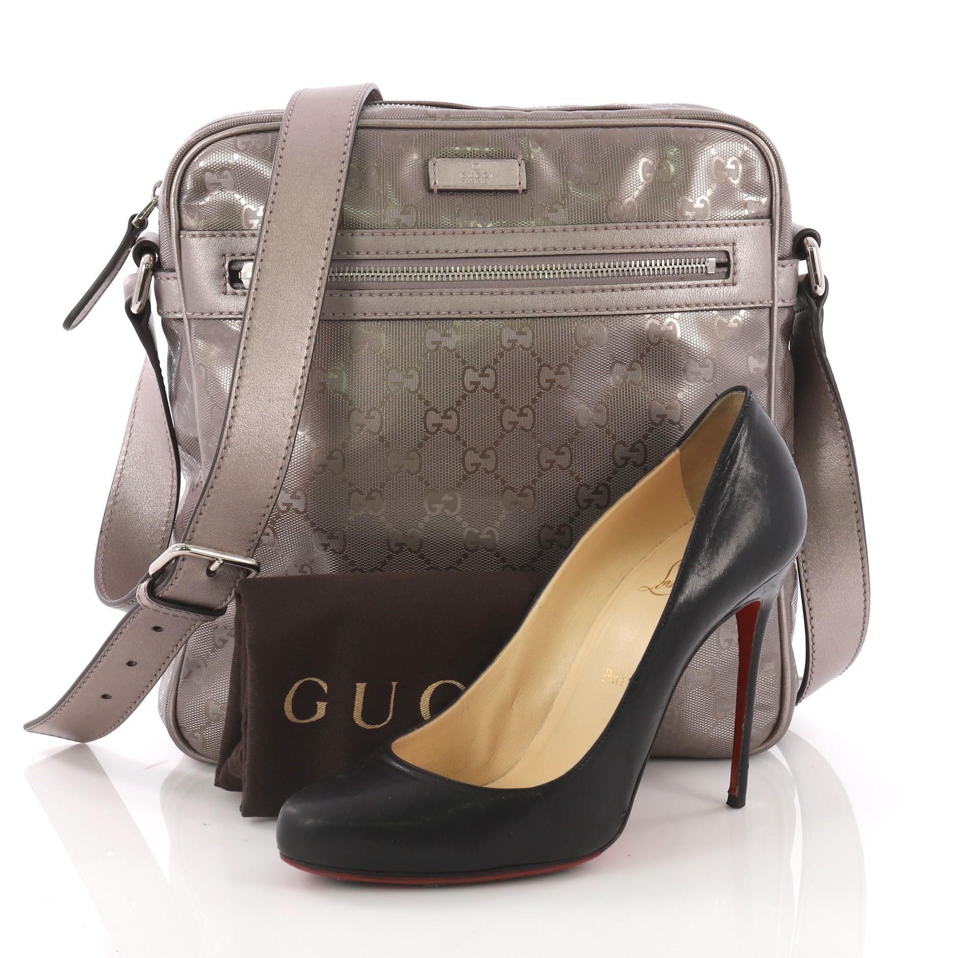 This Gucci Zip Crossbody Bag GG Imprime Medium, crafted taupe metallic GG imprime, features sturdy shoulder strap, exterior front zip pocket and silver-tone hardware. Its zip pocket opens to a black fabric interior with zip and slip pockets. **Note: