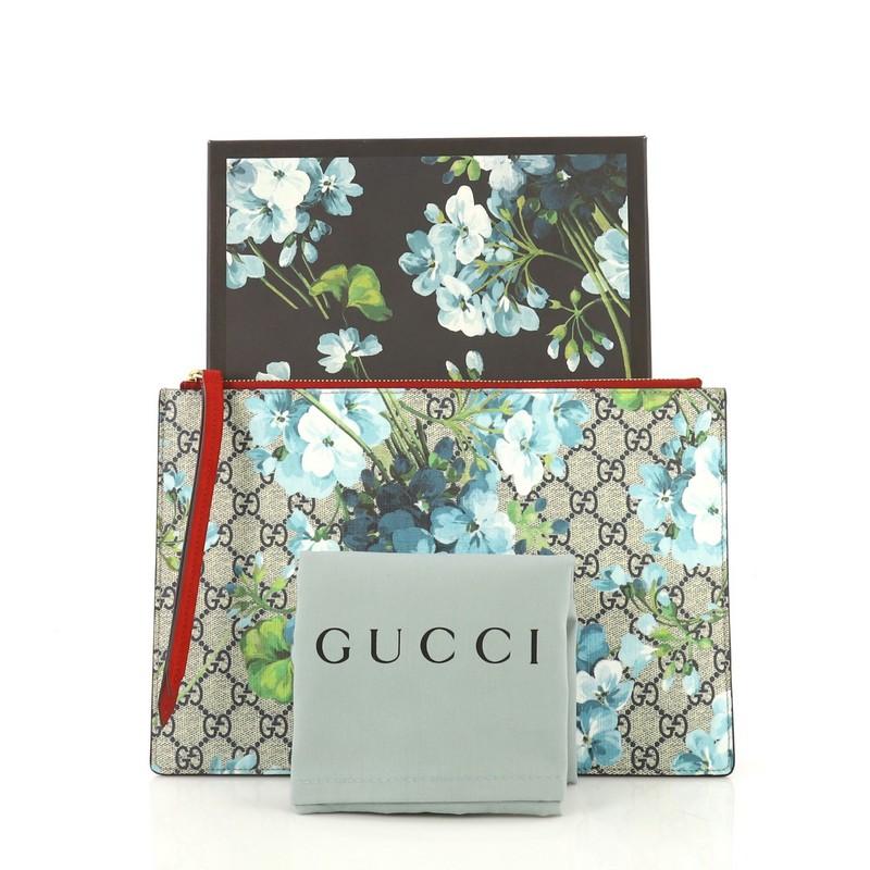 This Gucci Zipped Pouch Blooms Print GG Coated Canvas Large, crafted from blue blooms print GG coated canvas and red leather, features gold-tone hardware. Its zip closure opens to a beige suede interior. 

Estimated Retail Price: $620
Condition: