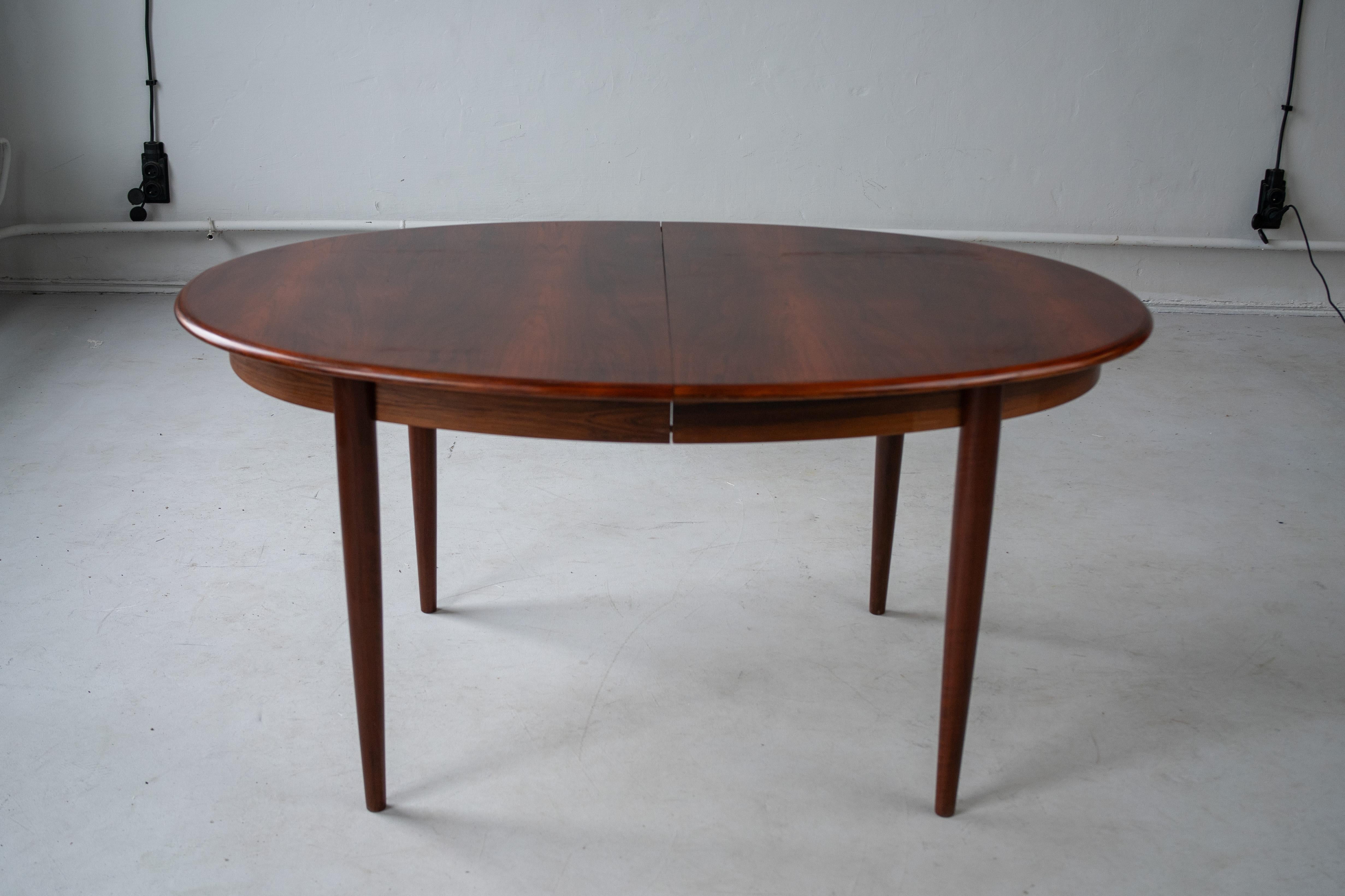 Wooden oval table, produced in Denmark by Gudme Mobelfabrik.
This table is extendeble, dark brown, mid-century piece.