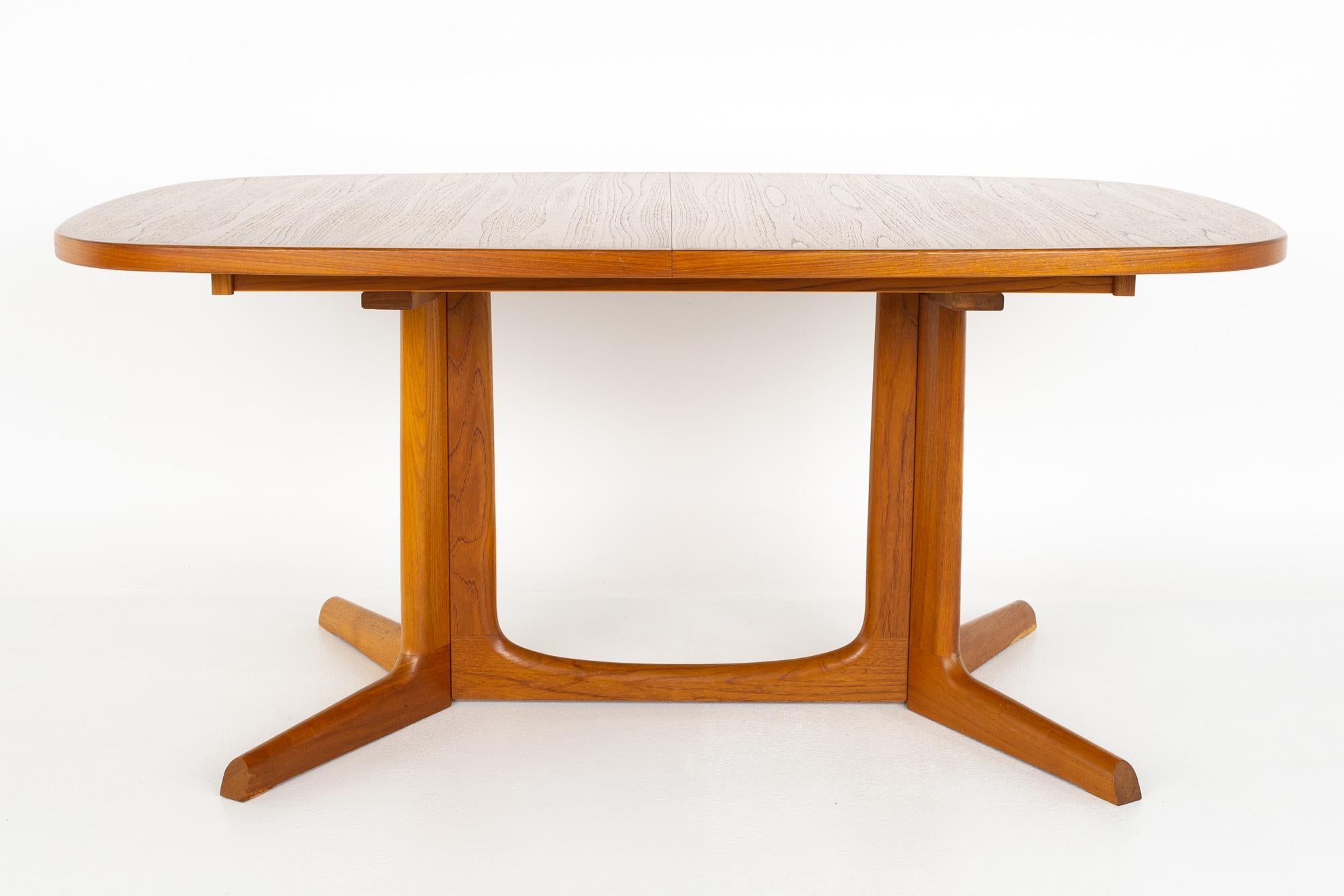 Gudme Mobelfabrik Danish mid century teak dining table with 2 leaves

Table measures: 64 wide x 41.5 deep x 28.5 inches high, with a chair clearance of 25.5 inches; each leaf is 19 inches wide, making a maximum table width of 102 inches when both