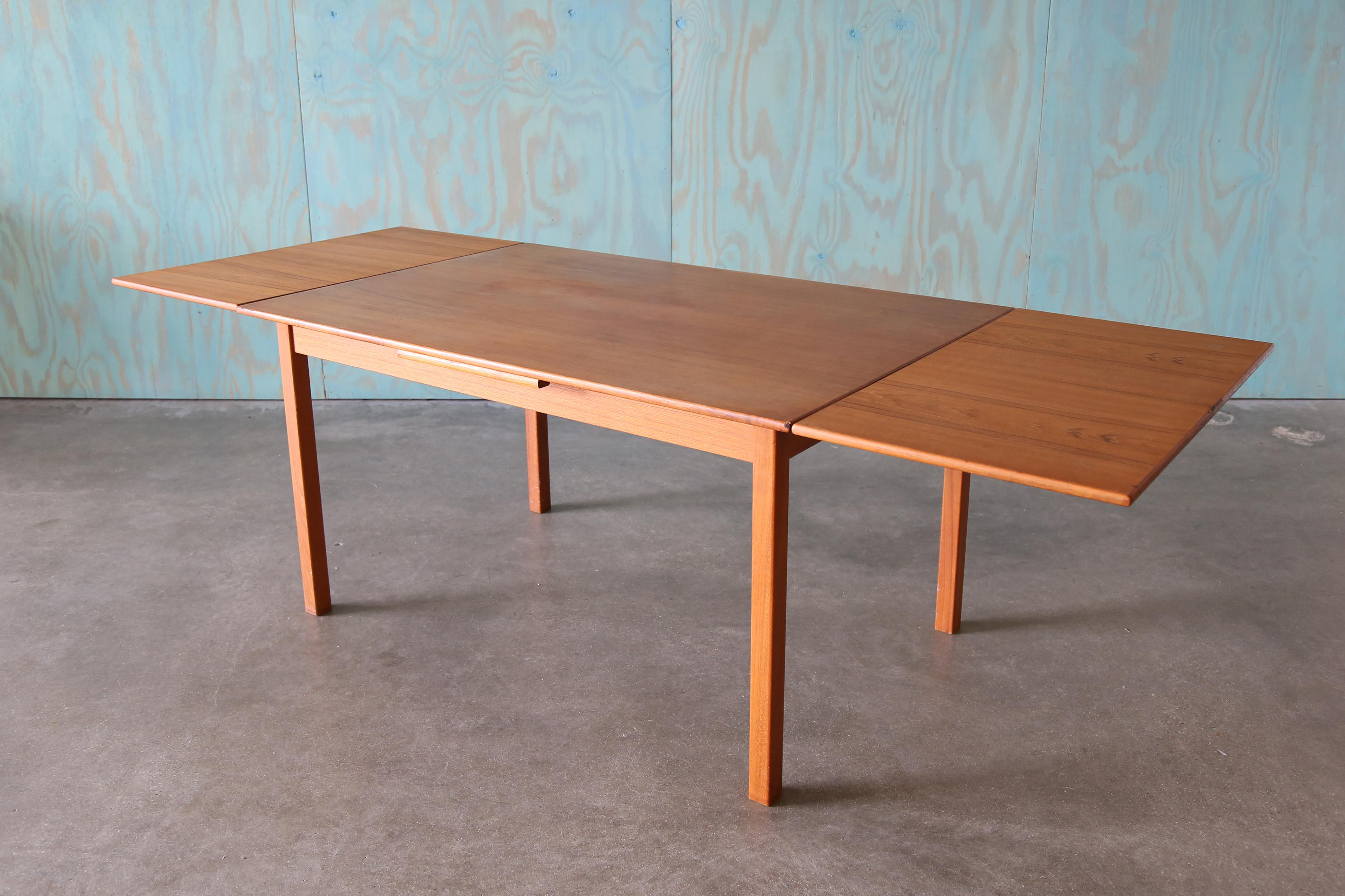 A refectory teak danish dining table, featuring two hidden leaves that can individually slide out.  A great compact design perfect for smaller dining rooms with easy conversion to accommodate extra guests. A timeless danish classic. 