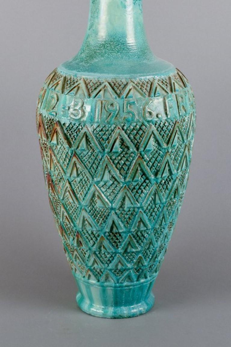 Gudmundur Einarsson (1895-1963), Icelandic ceramist. 
Ceramic floor vase featuring geometric panels and text in the decoration: 