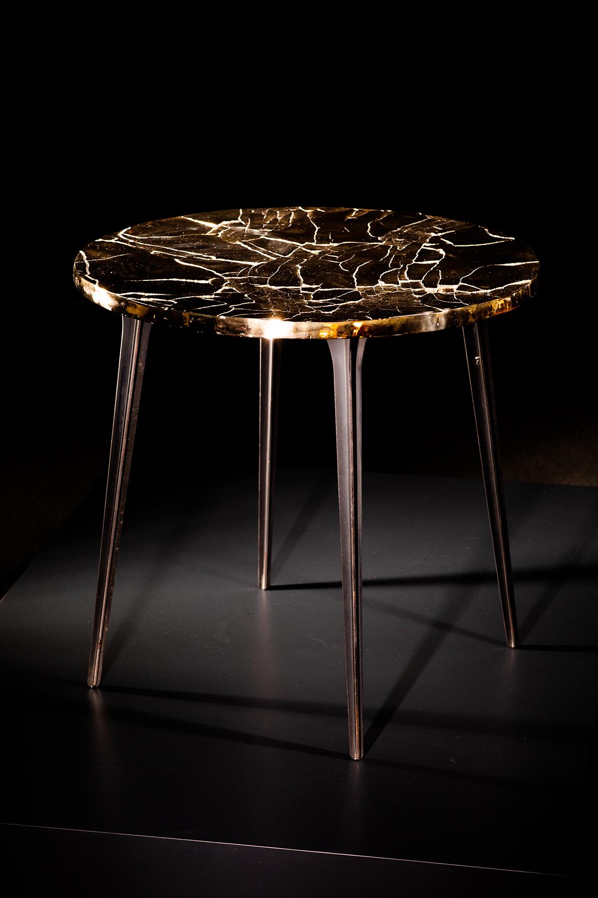 Cast bronze top in Boulloud’s fractured style, finished with a high shine, raised on partially patinated steel legs.