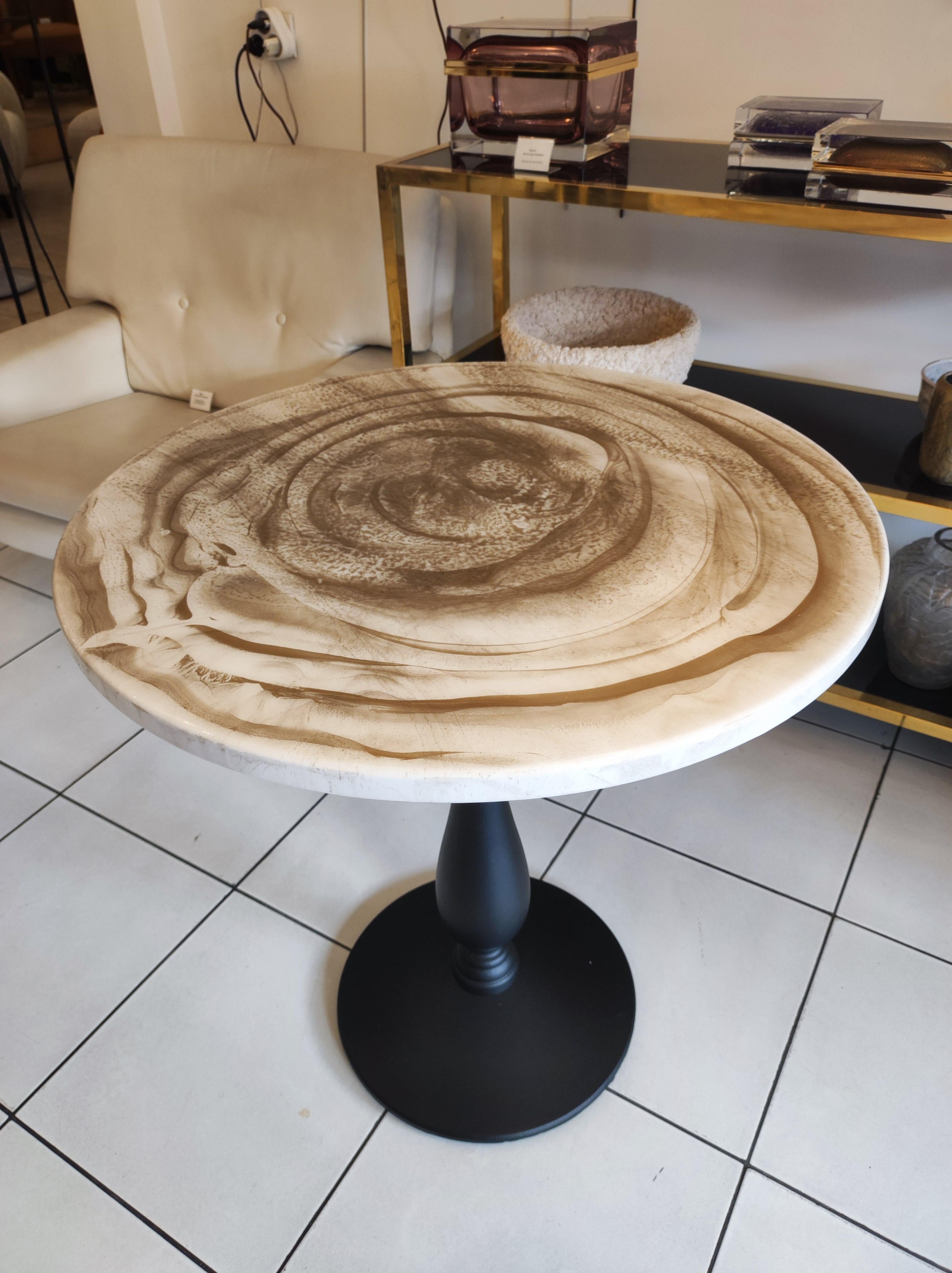 Gueridon / bistro table, cast iron painted black foot and laquered wood top with golden effects.