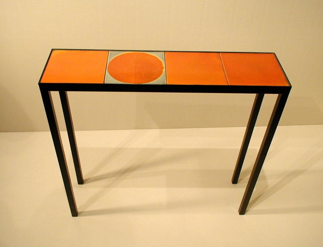 This coffee table / console is made with 4 ceramic tiles made in the 1970's by Roger Capron, one of the most well-known ceramist of the Modern era.  Each tile is unique, hand-glazed and varied in color and texture. We use these tiles to create