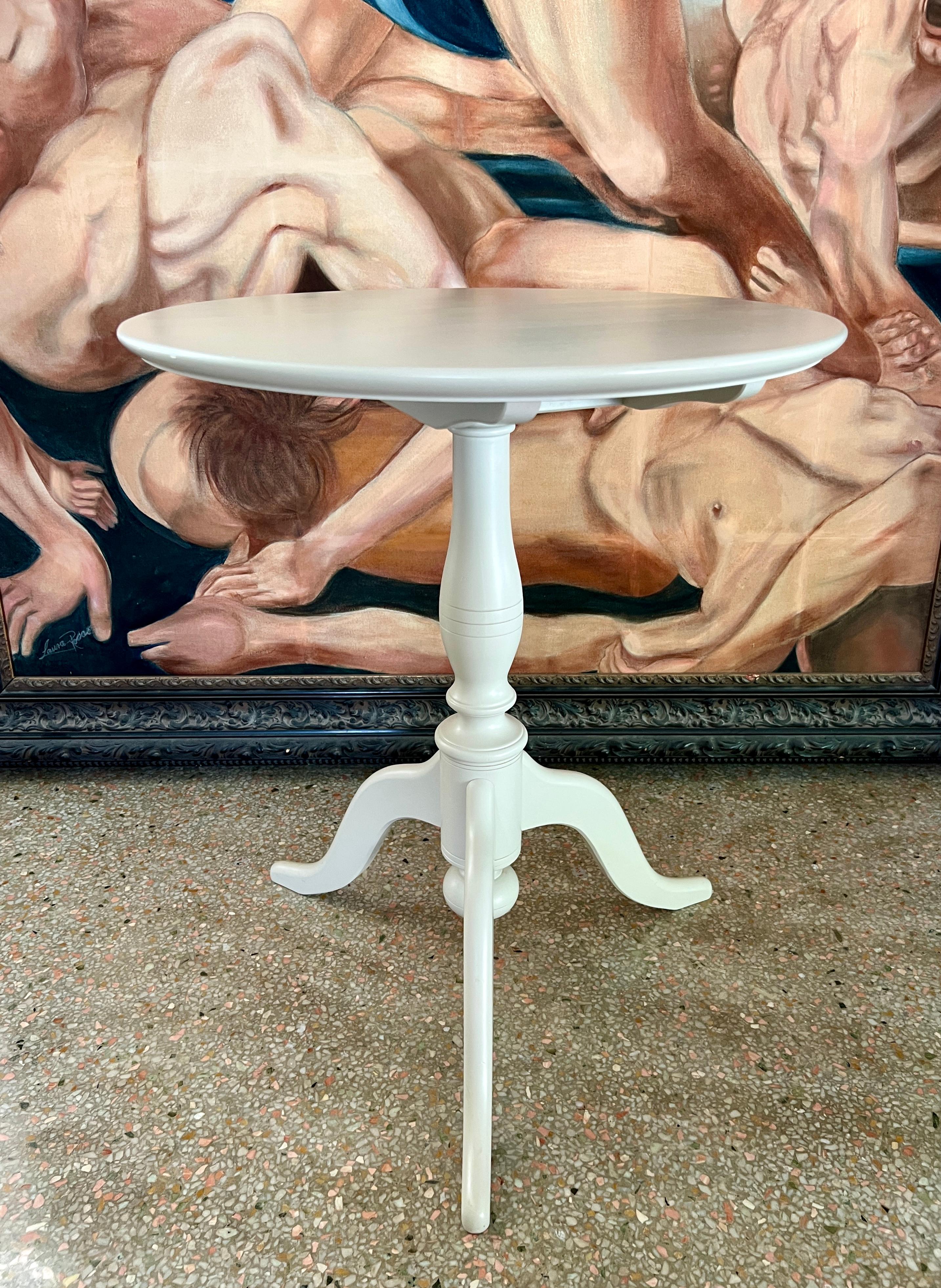 Gustavian style table based on antique guéridon tables from 19th Century Sweden, with tilted top feature. The tilt mechanism allows the tabletop to fully turn and lock sideways while not in use. The wood table has a round top with a tripod base. It