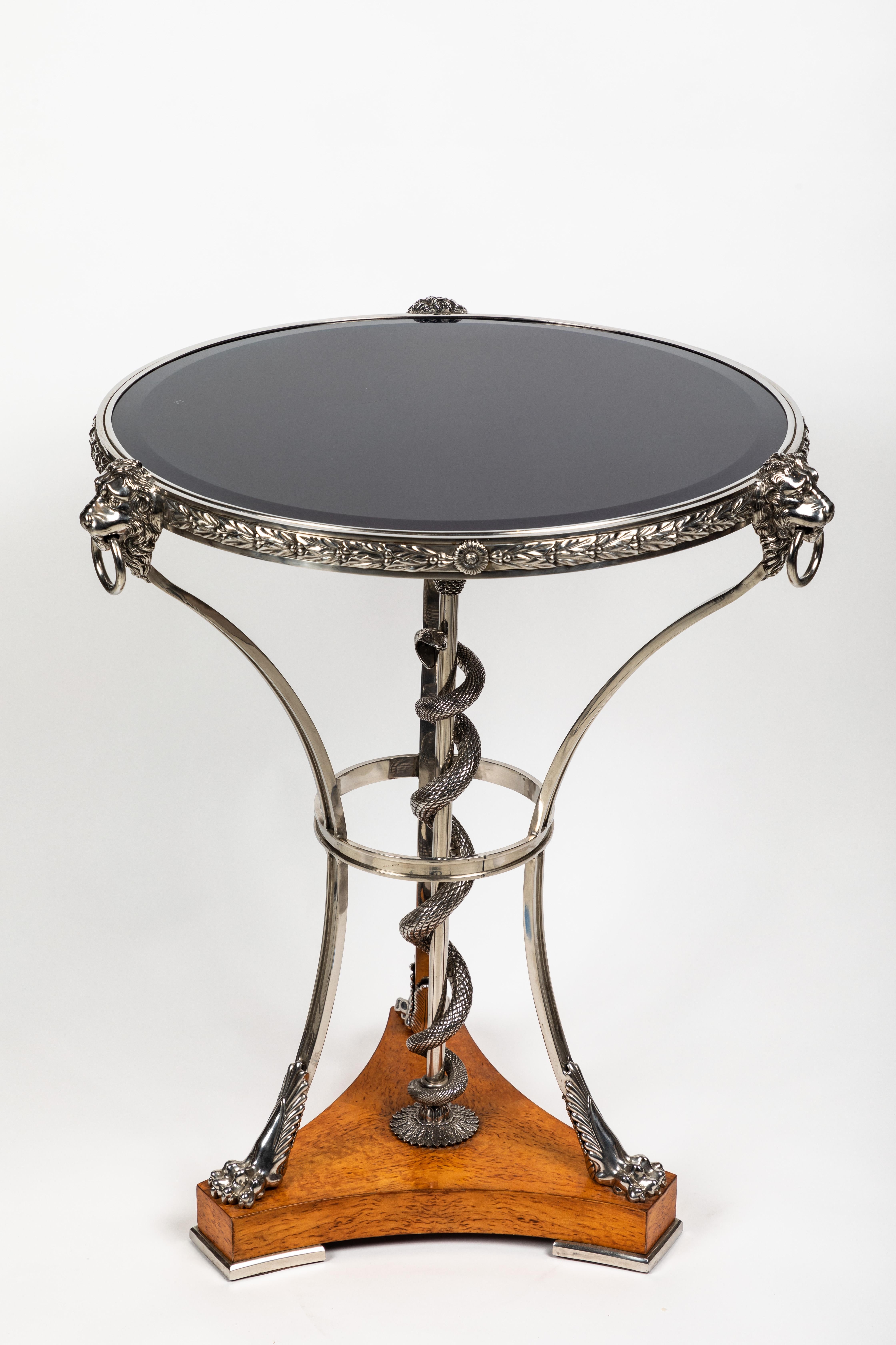 An absolutely beautiful table from the St. Petersburg palaces collection is copied from a table from Pavlovsk palace. The table is modern in its materials. Here is a description directly from the manufacturer:

A superb stainless steel lamp table,