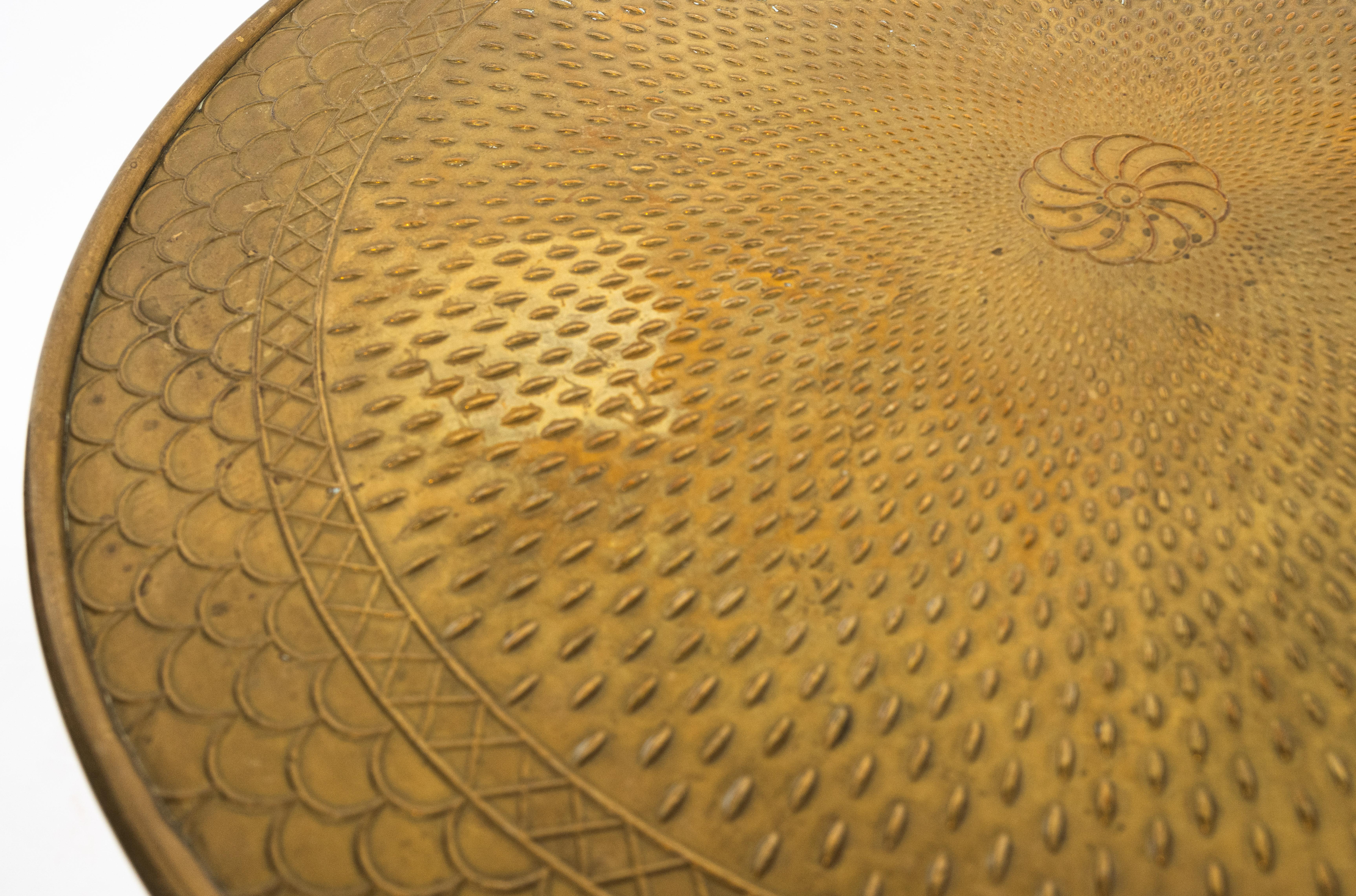Table d'appoint suédoise de style Arts and Crafts avec plateau en repoussé. Le bord est festonné avec des motifs en relief et une rosette centrale. Le plateau en laiton est soutenu par une base avec des pieds en bouleau massif reliés par un châssis