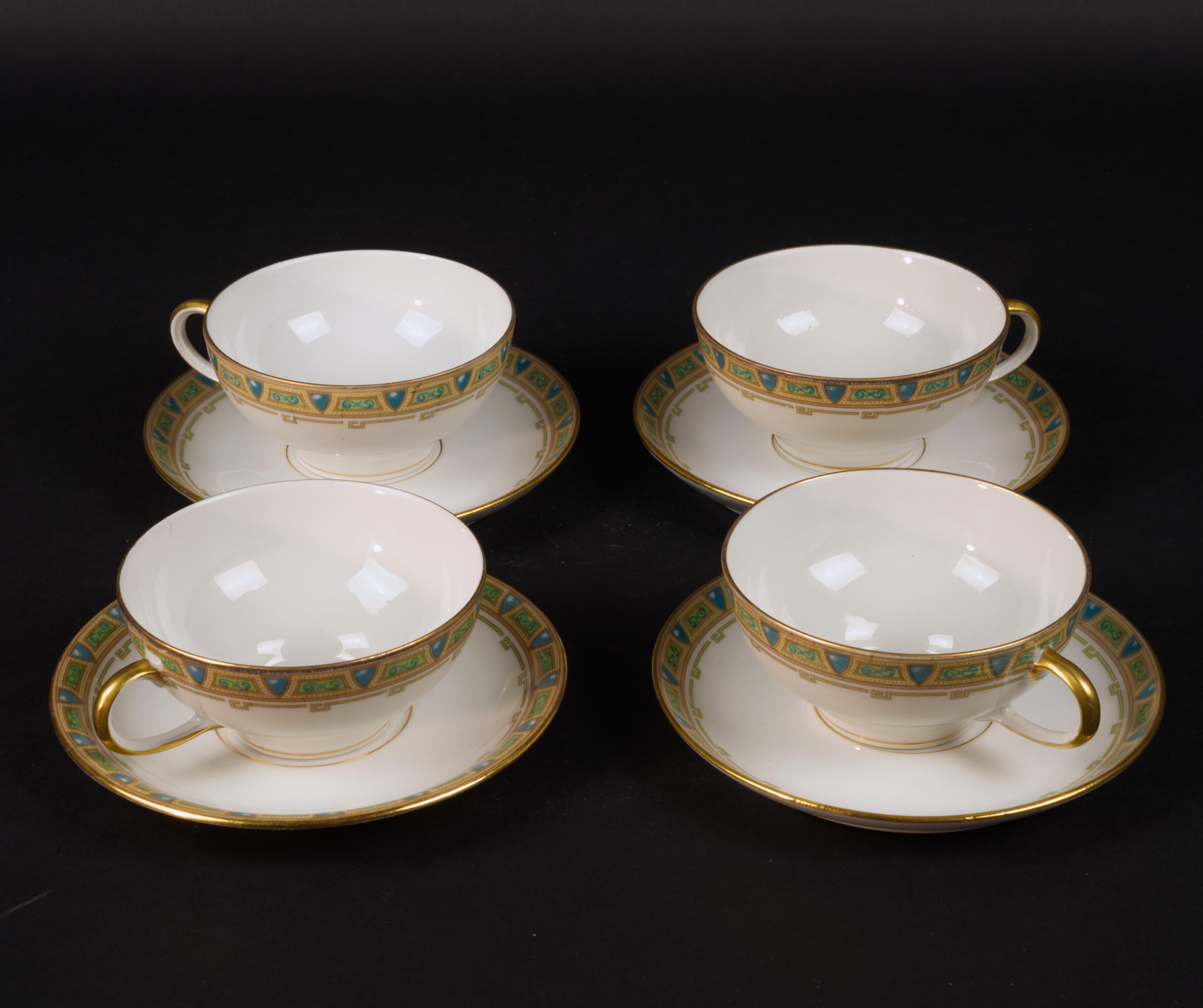 
Set of four cups and four saucers by Guerin &Co was made of fine, semi-transparent bone china in Limoges, France. The set is hand decorated in Neoclassical or Regency style with ornamental blue and beige border and gold trim on rims and cup