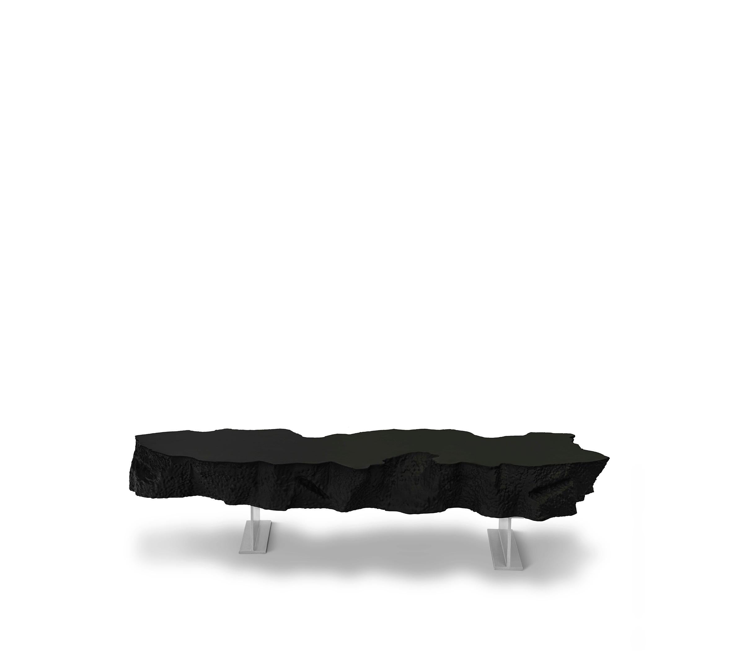 The Broken Bench, an irregular slab of “soft concrete” in polyurethane, seems to be the part missing from the large Broken Mirror, and just like the other pieces of the collection plays with the “short-circuit” between the actual softness of the