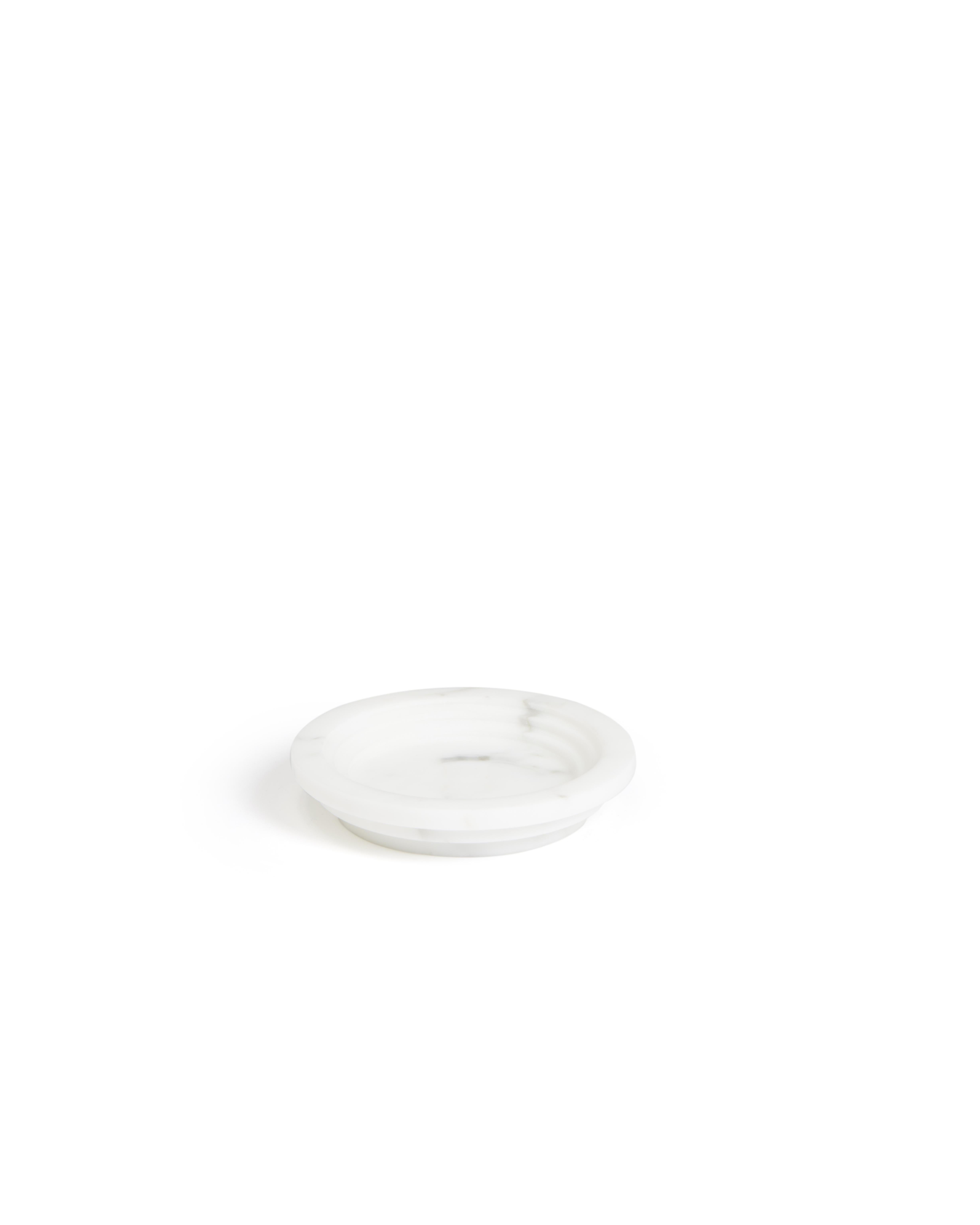 Guggenheim round ashtray by Michele Chiossi
Dimensions: 16 x 16 x 3 cm
Materials: Bianco Michelangelo marble

His research is defined by the ongoing analysis of the mood that marks our daily lives, which he manifests through original still-lives