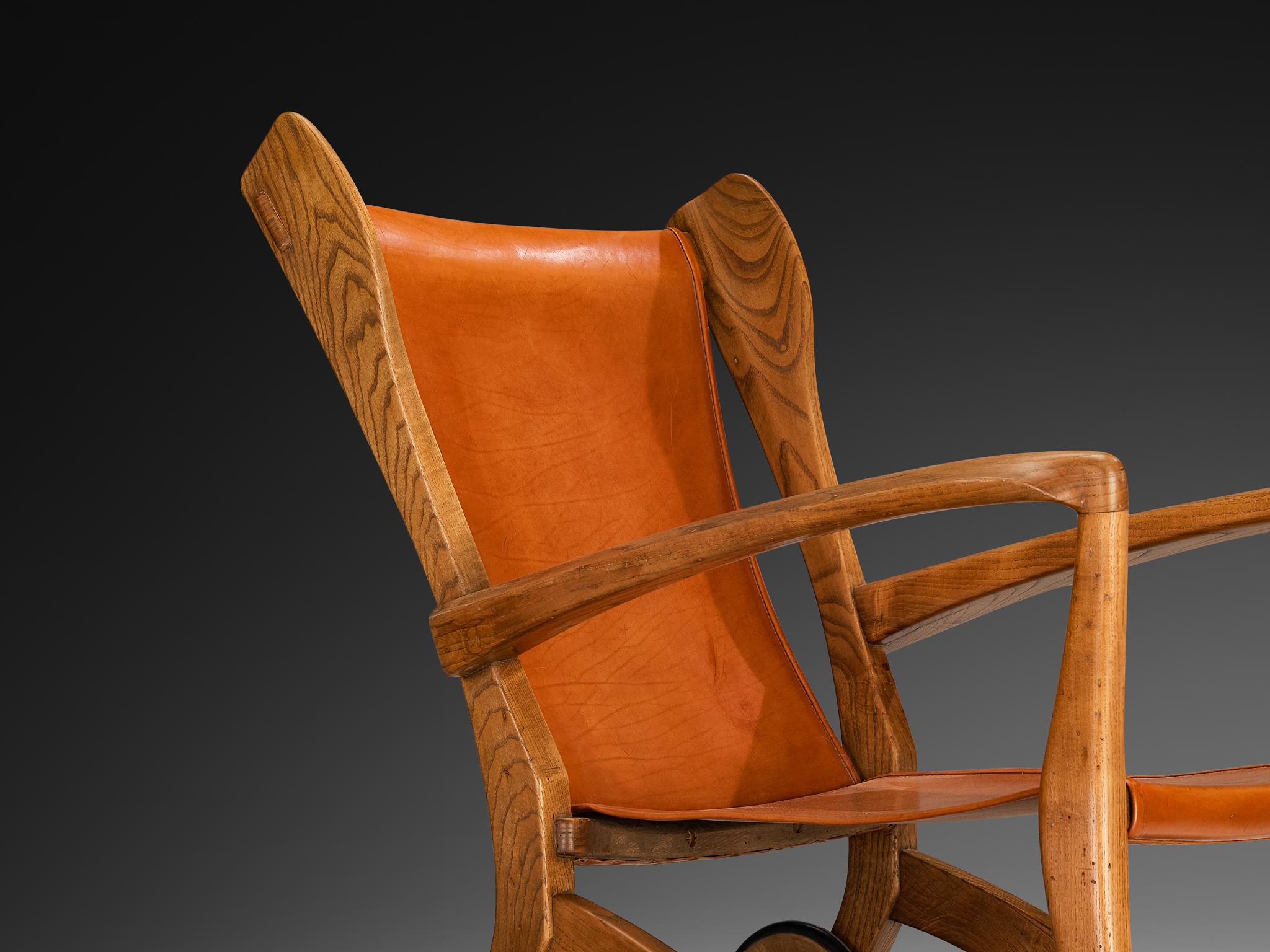 Guglielmo Pecorini, high back lounge chair, ash wood, leather, brass, Italy, 1950s

Wonderfully sculpted oak chair featuring rich brown-reddish leather upholstery. Designed by Italian designer Guglielmo Pecorini, this piece masterfully combines