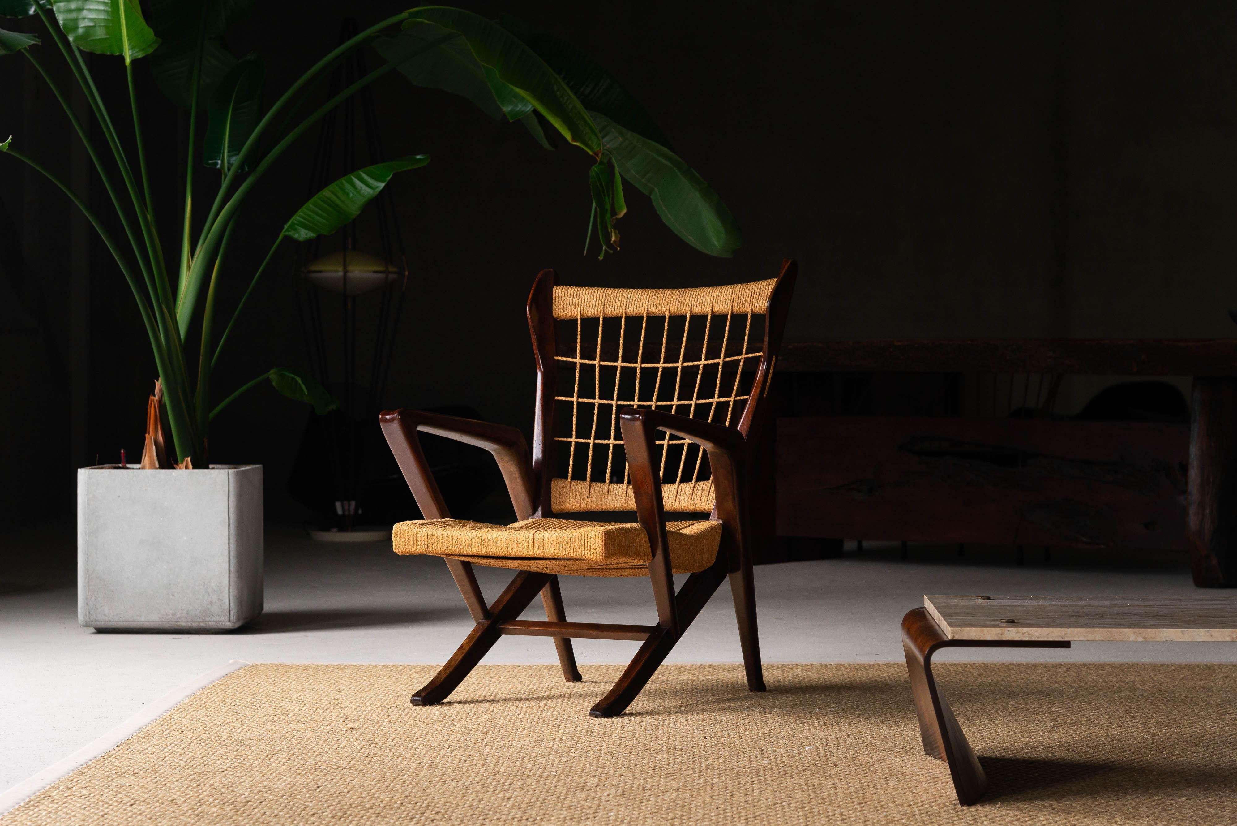 This rare early armchair designed by Guglielmo Pecorini and expertly crafted by Edizioni I Due Forni is a true testament to the marriage of form and function. The frame, constructed from dark stained walnut wood, boasts a dynamic shape that exudes
