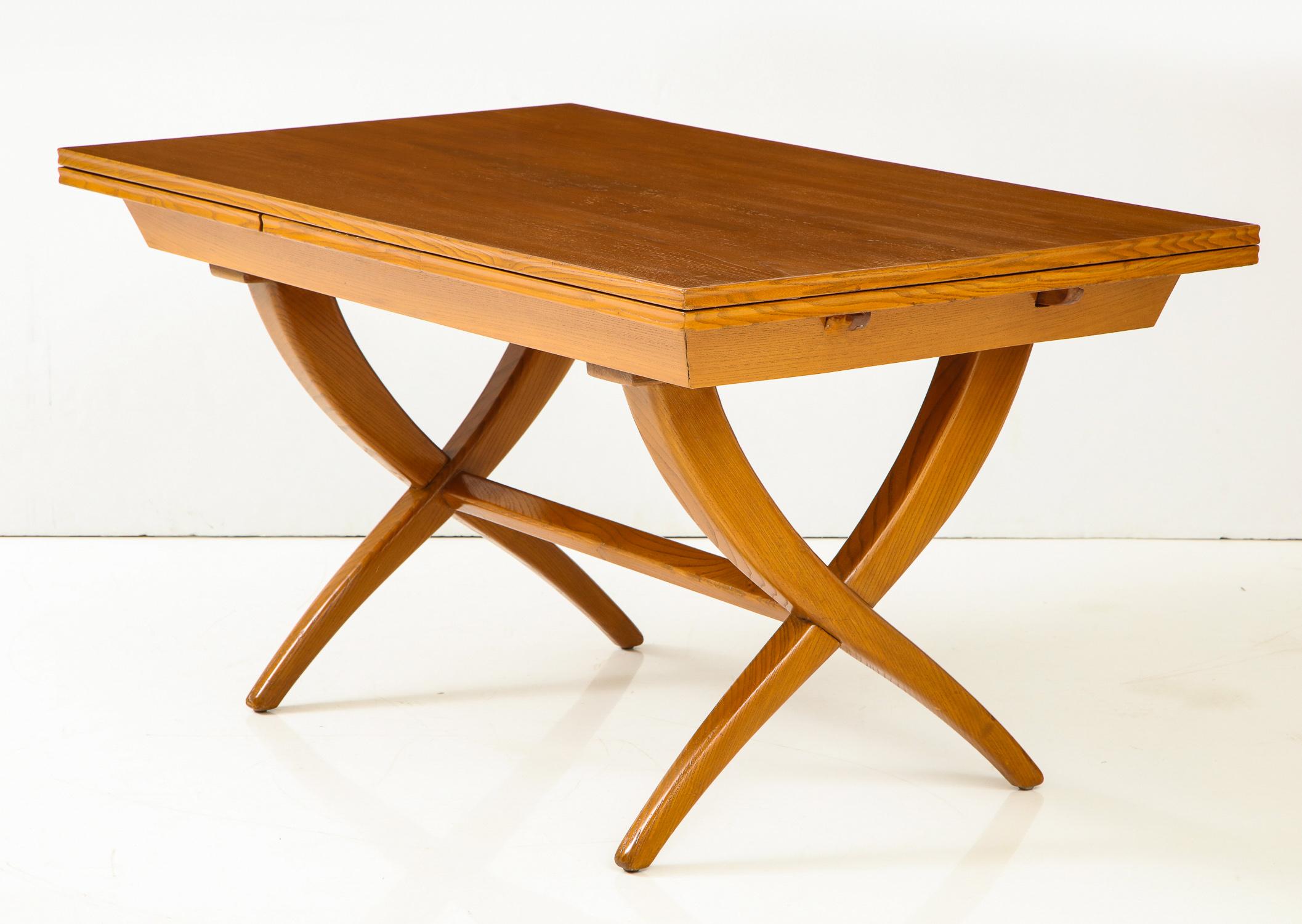 Handcrafted extension table of boldly grained oak with chamfered edges and inset leaves by Florentine artisan and designer Guglielmo Pecorini, produced in Italy circa 1950 and purchased by the previous owner from Lord & Taylor in 1951. The graceful,