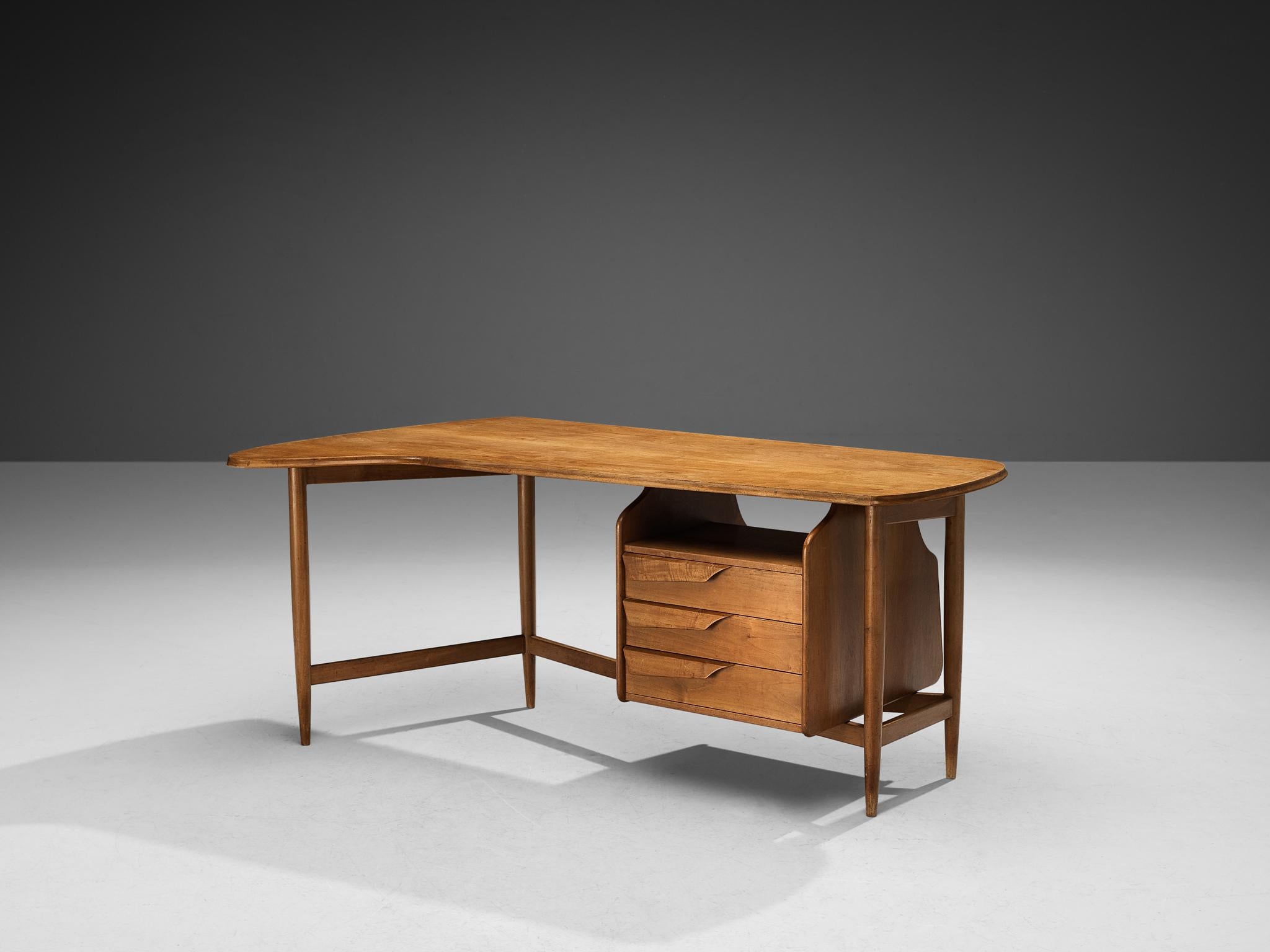 Guglielmo Pecorini, writing desk / table, walnut, Italy, 1945. 

This eccentric writing desk is well-constructed in a precise manner implementing geometrical shapes that contribute to its architectural appearance. The tabletop and compartment are
