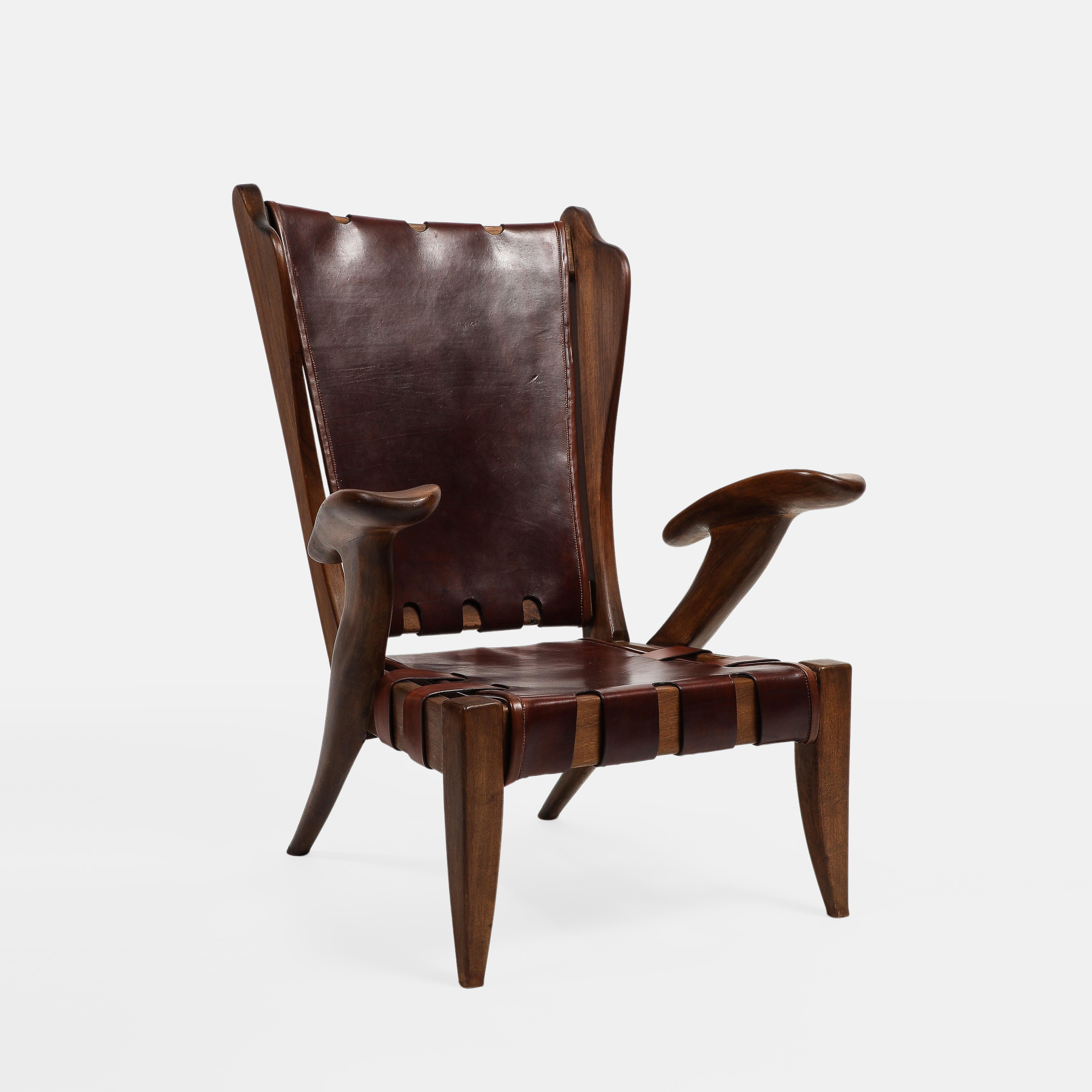 Guglielmo Pecorini rare early rustic highback lounge chair or armchair with walnut frame and original burgundy leather back and seat, Italy, 1940s.  This sculptural lounge chair has a dynamic carved frame composition including subtle wingback,