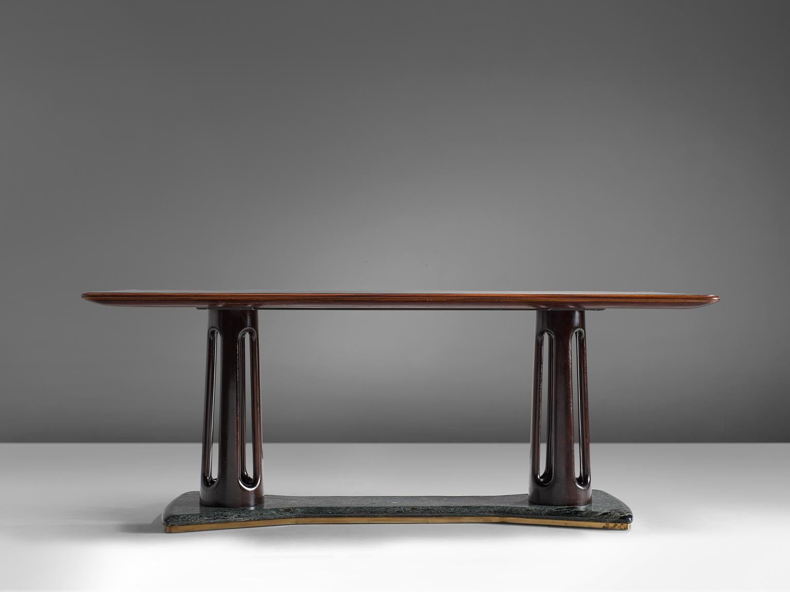 Attributed to Guglielmo Ulrich, dining table, wood, glass, brass and serpentine marble, , Italy, 1940s. 

Luxurious table with rectangular top. The top consist of glass with wooden trim. Two round columns with nice carved details. Serpentine