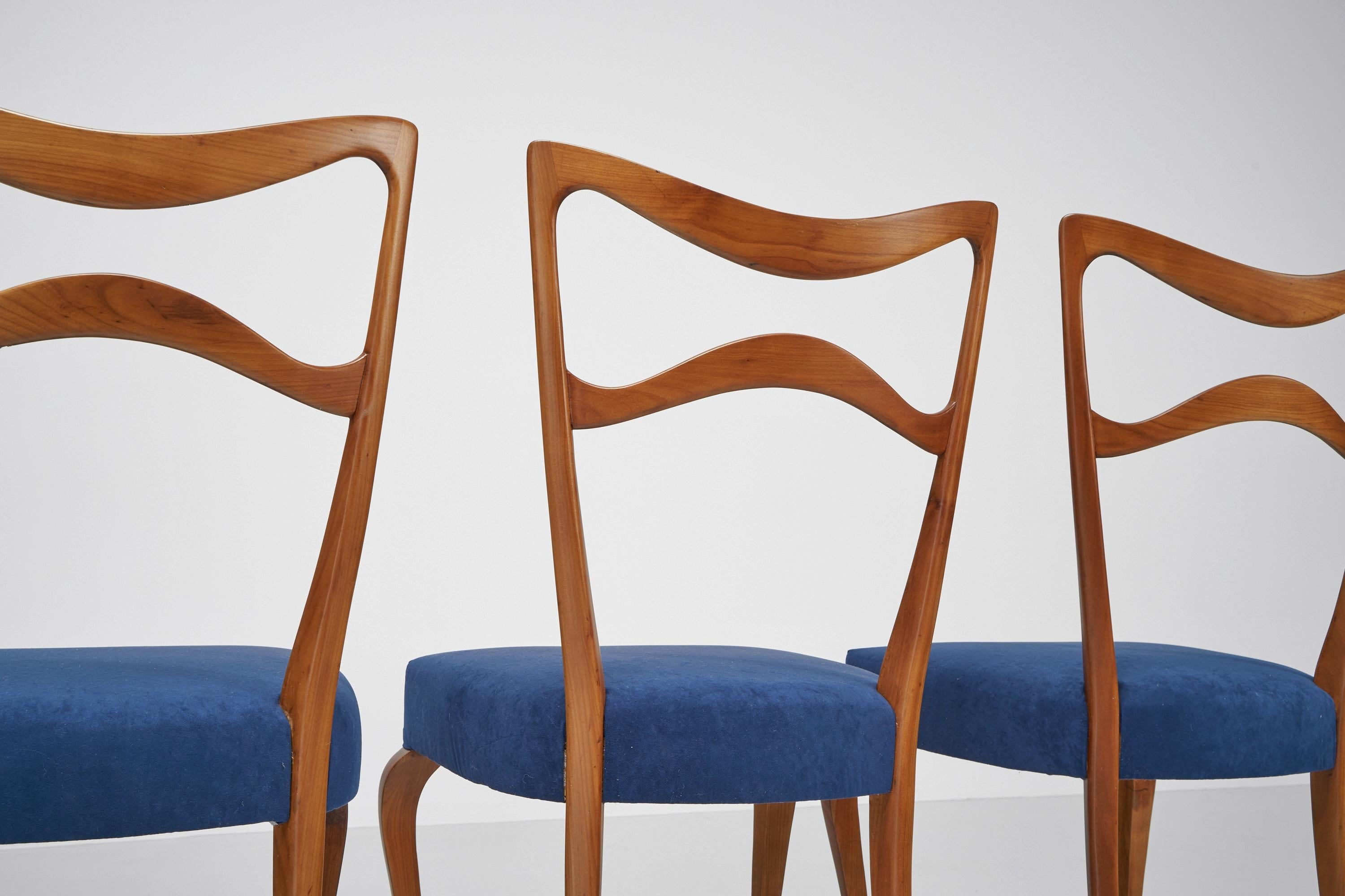 Stunning set of dining chairs designed by Guglielmo Ulrich and produced in Italy in 1950. This set consists of six chairs and has been fully restored in our own atelier with a matte gloss finish, and are reupholstered in a blue velvet. The chairs