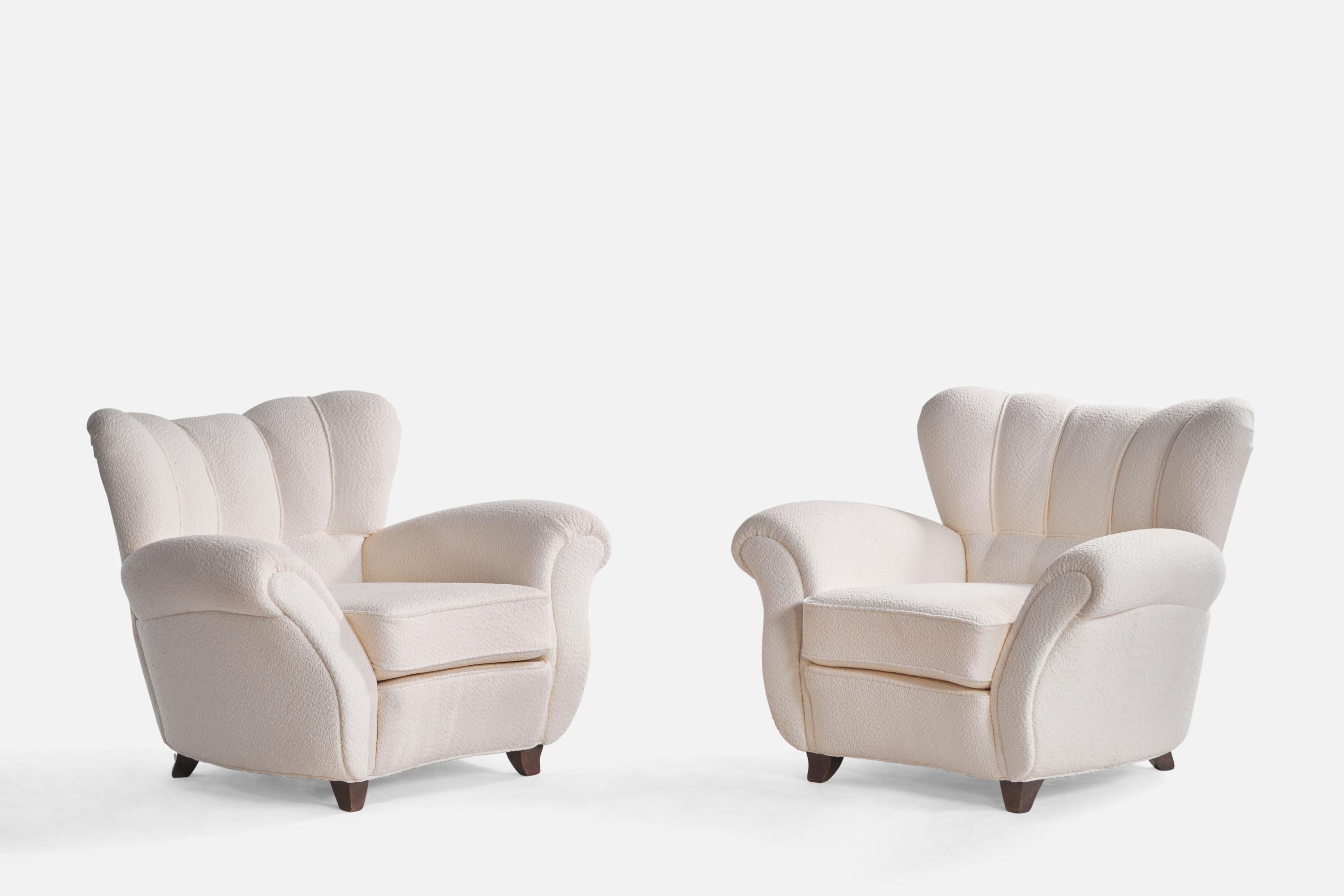 A pair of wood and white bouclé fabric lounge chairs designed and produced by Guglielmo Ulrich, Italy, 1940s.

Seat height: 17”

Reupholstered in brand new fabric.