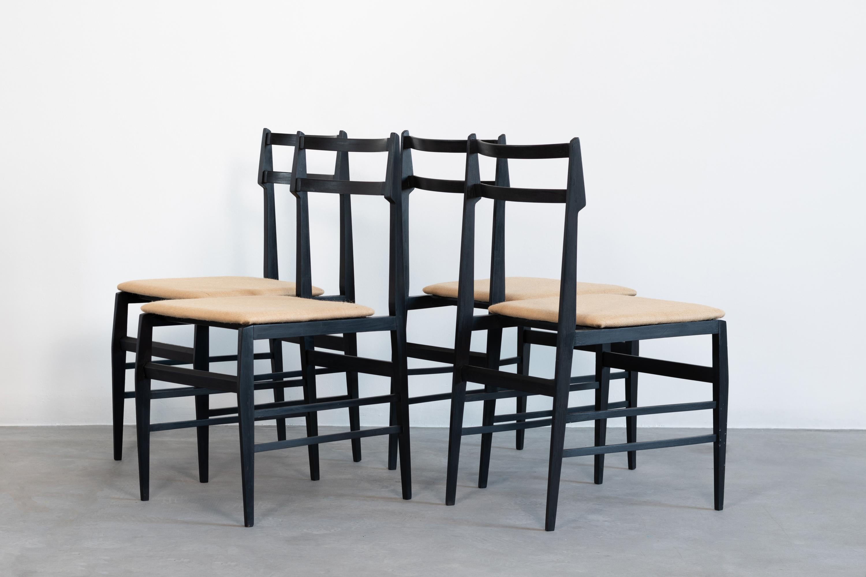 Four dining chairs by Guglielmo Ulrich (attrib.), with ebonized wood structure covered with fabric, produced by Saffa, in 1960s. 
Measurements: 83 x 41 x 50 cm (each)

Guglielmo Ulrich was an Italian architect. He was a student of ‘Scuola