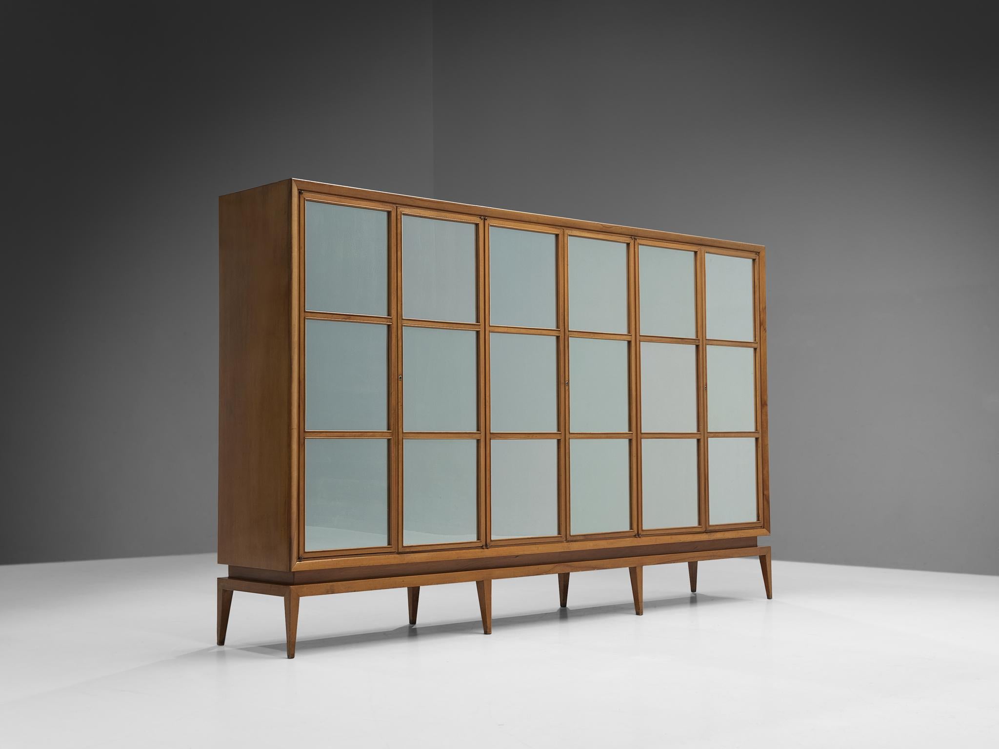 Guglielmo Ulrich, wardrobe, walnut, glass, Italy, 1940s. 

This large wardrobe designed by Guglielmo Ulrich convinces visually through its geometrical shapes and graphical doors complemented with eighteen square mirrors that specialize the design