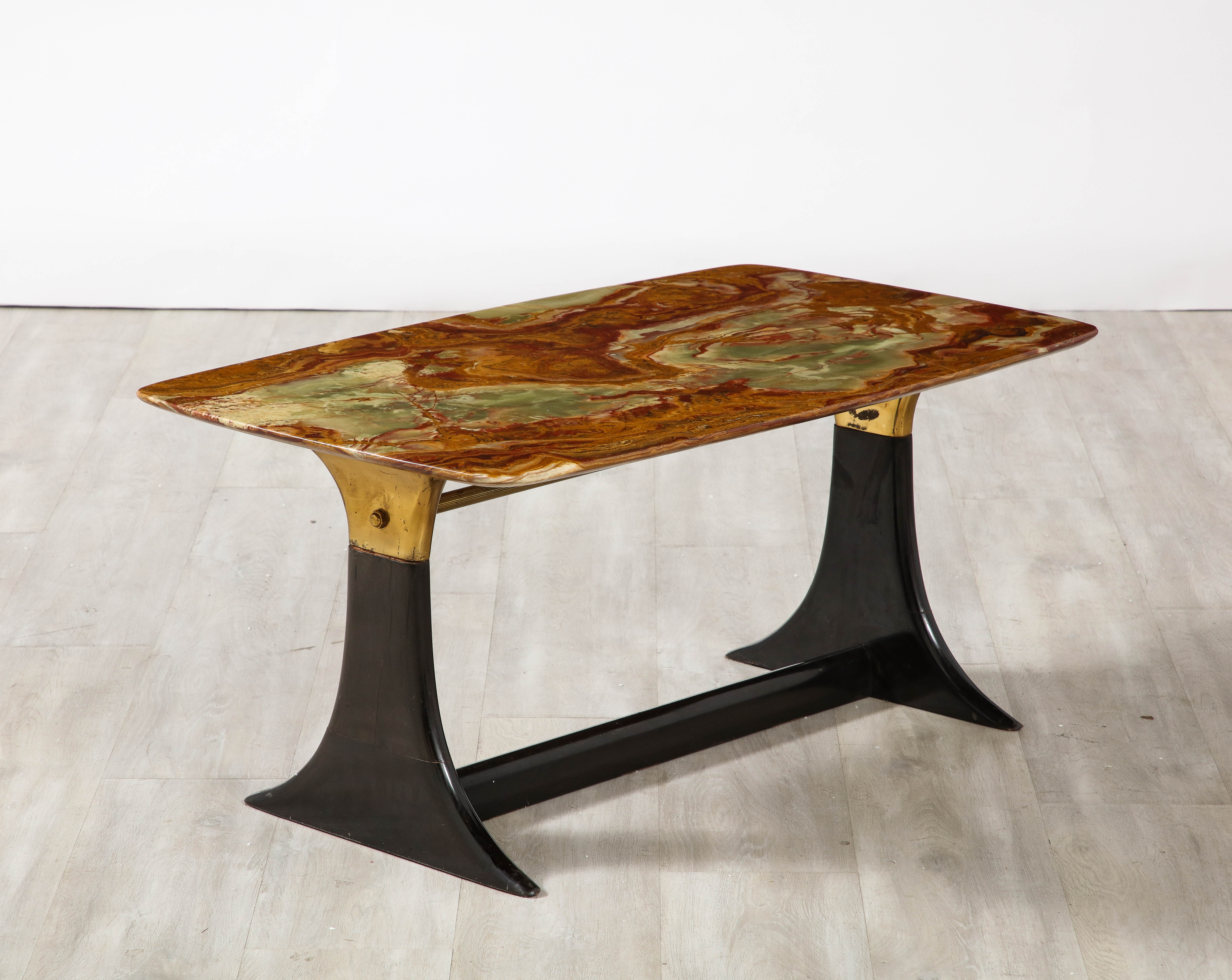 Superb walnut and brass coffee table designed by Italian mid-century designer, Guglielmo Ulrich. The stunning rectangular agate top in variations of greens, red, brown and cream, rests atop a shaped walnut and brass base with brass stretcher at the