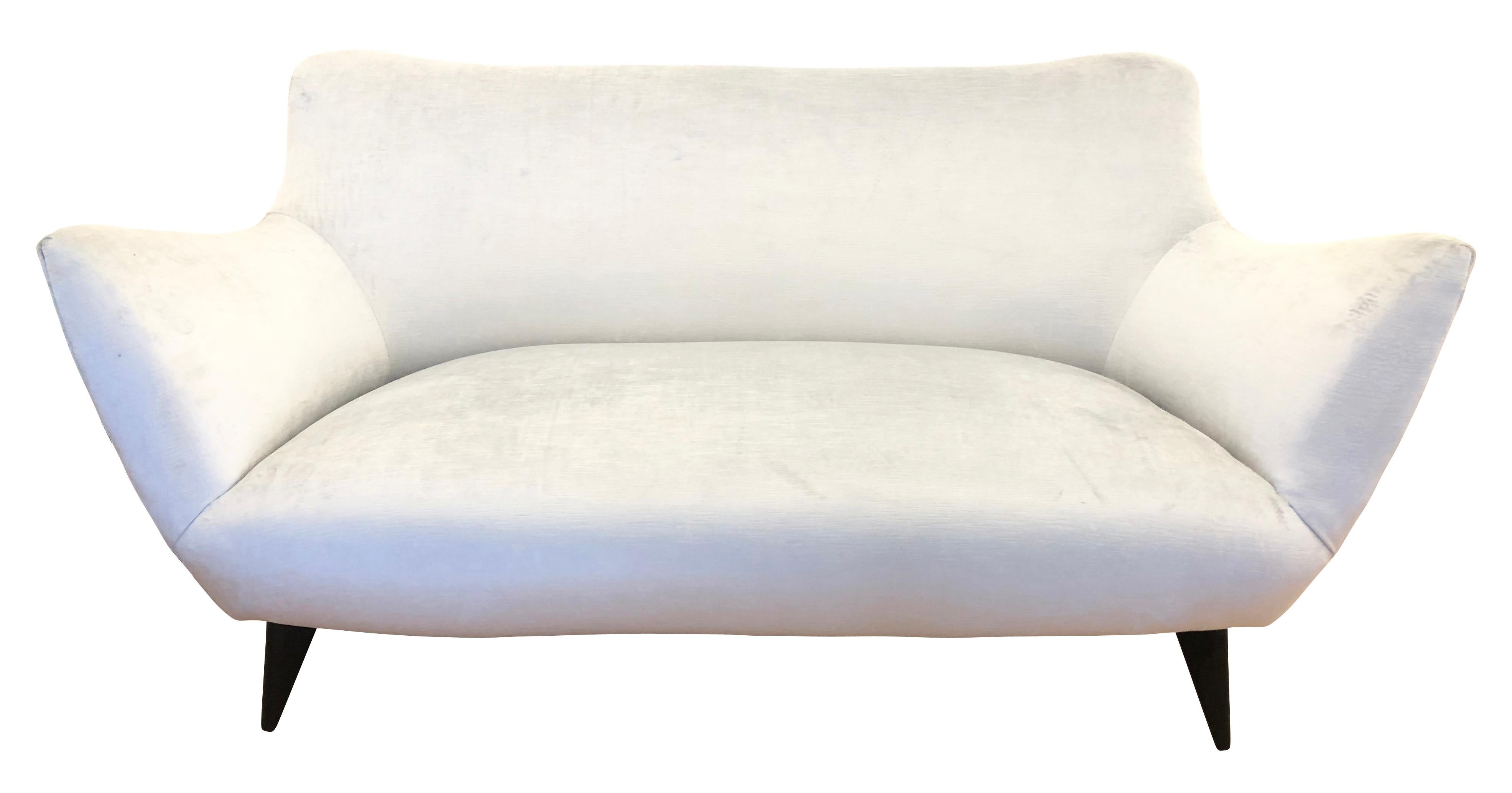 Beautifully designed and balanced “Perla” sofa by Guglielmo Veronesi for ISA from the 1950s. Its curved lines and tapered wooden legs give it a sensual and modern feel. Has been re-upholstered in a light blue velvet.

Condition: Excellent vintage
