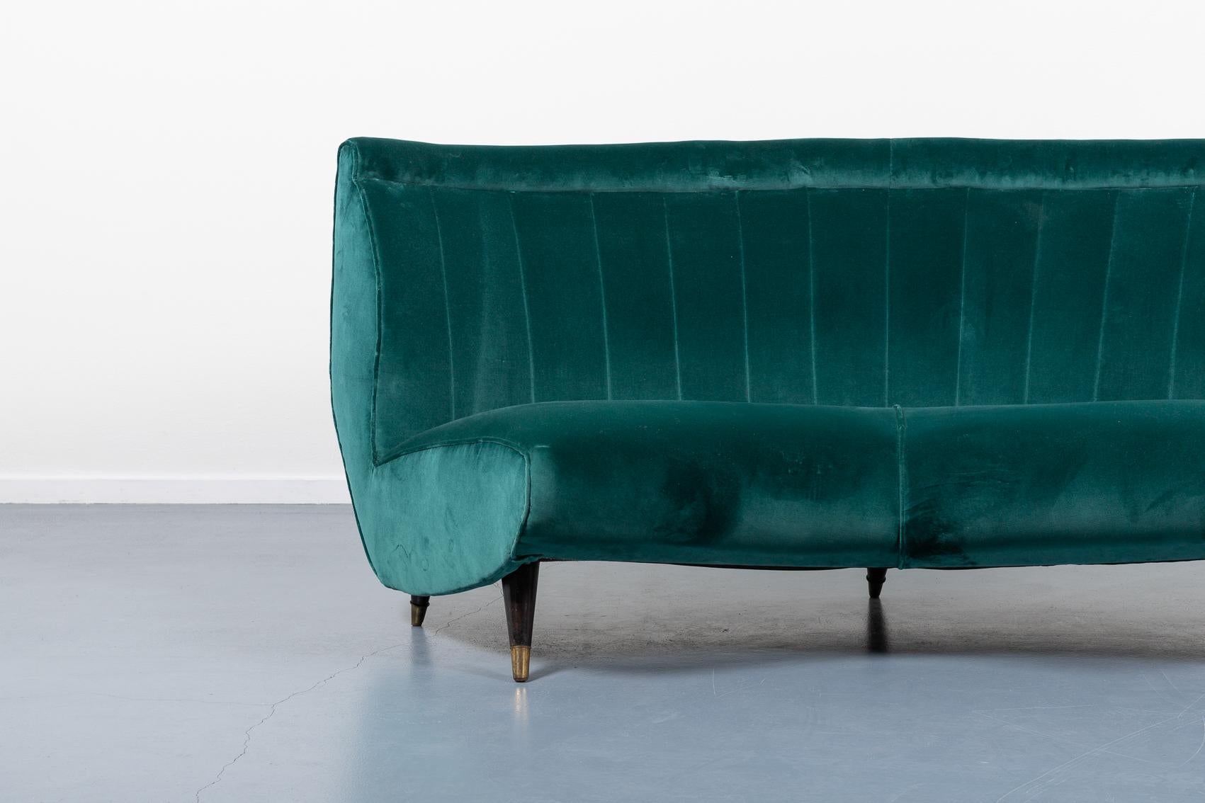 Rare Italian Mid Century Modern curved sofa designed by Guglielmo Veronesi for ISA production. It features sculptural wooden frame with velvet fabric upholstery, leather legs with brass feet.

Condition
Good, later upholstery

Dimensions
width: